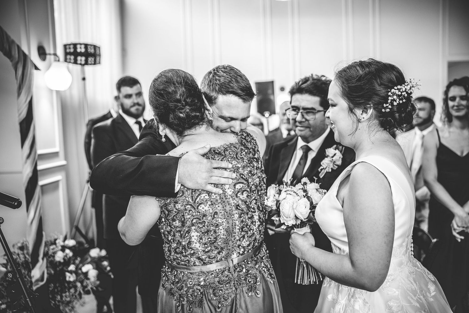 Black and white candid shots of wedding party members during reception celebrations.