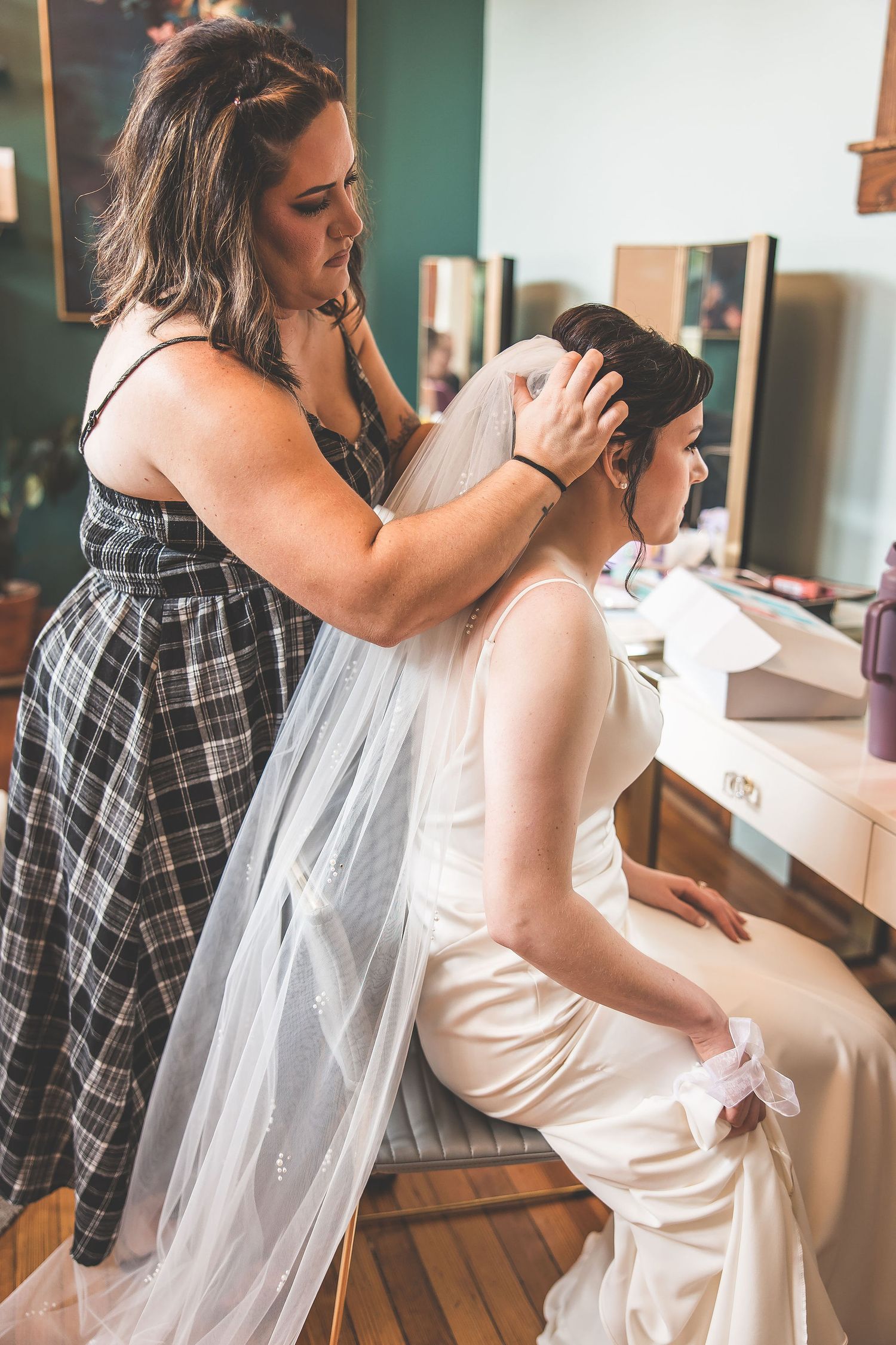 Wedding dress preparation sequence showing final adjustments and details.
