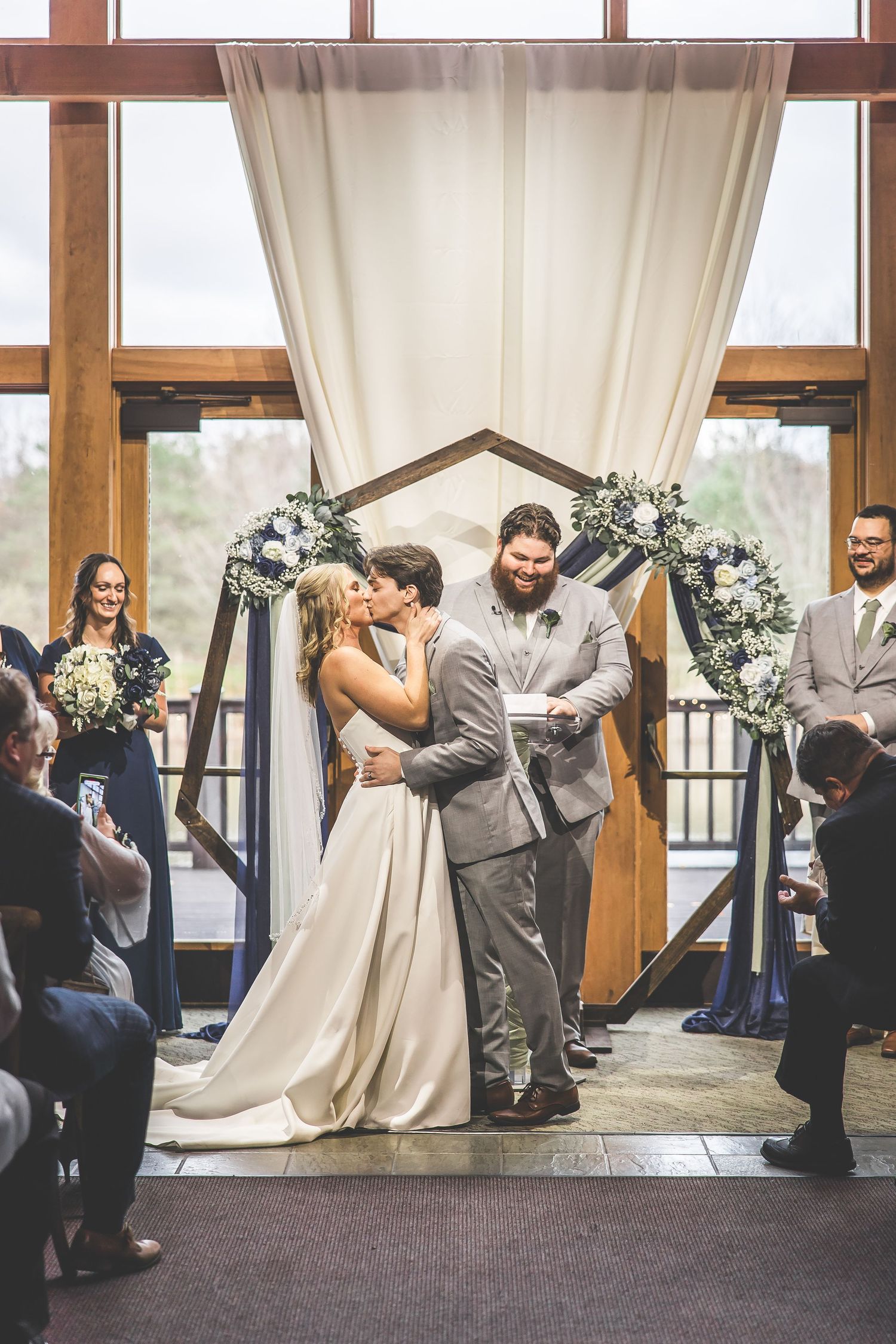 Wedding ceremony sequence in an elegant venue with large windows and white drapery.