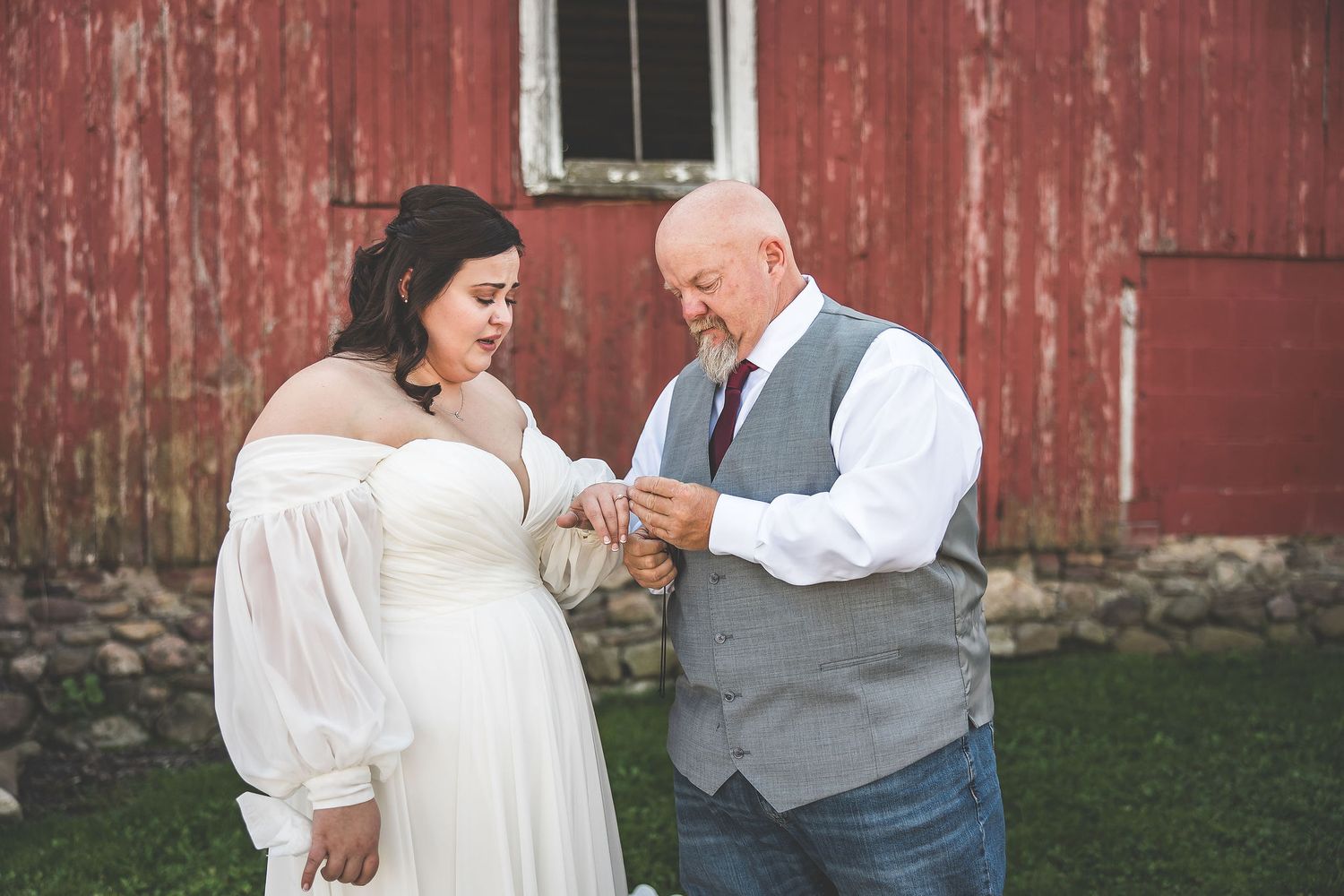 Newlyweds share candid moments during their barn wedding photoshoot.