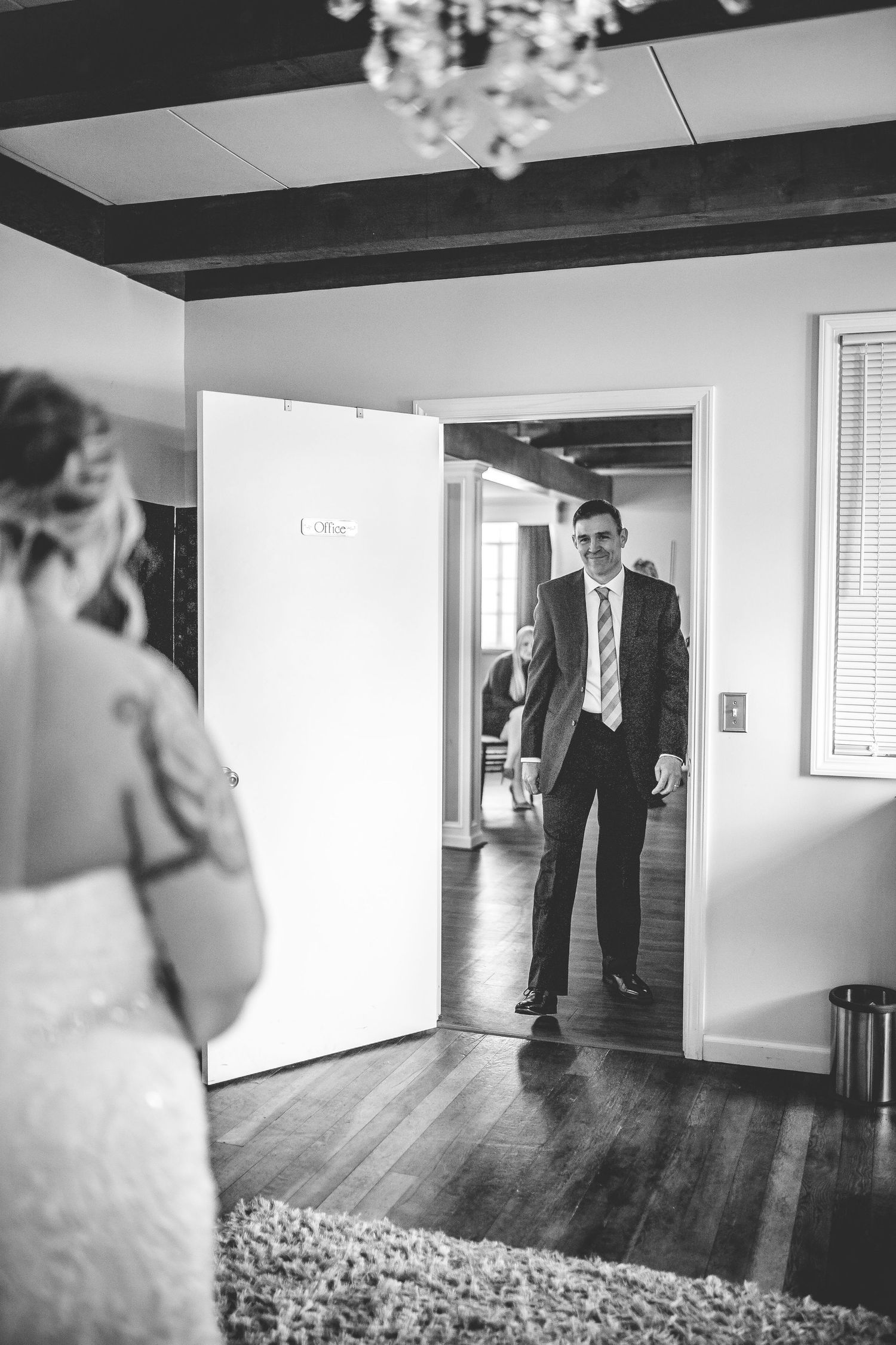 Black and white sequence of first look moments in an elegant indoor setting.