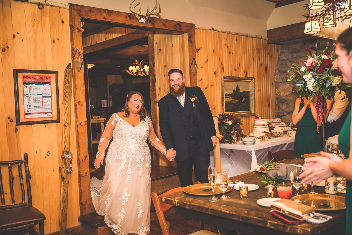 Reception venue decorated with wooden panels and warm lighting for wedding celebration.