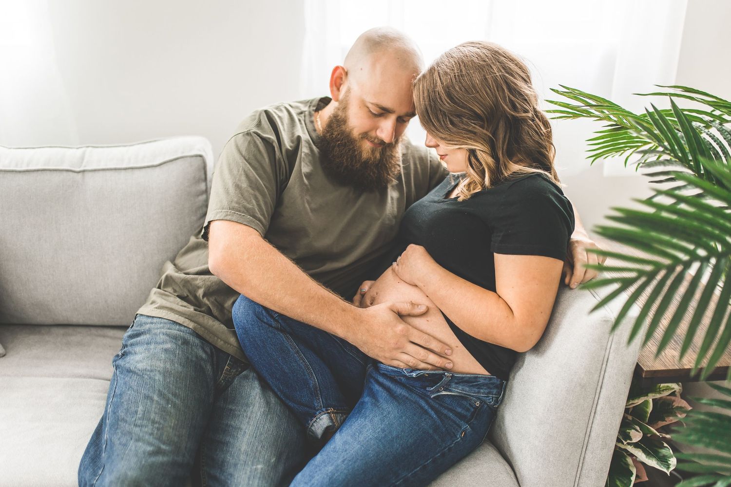 Cozy lifestyle photos on white couch with casual intimate moments.