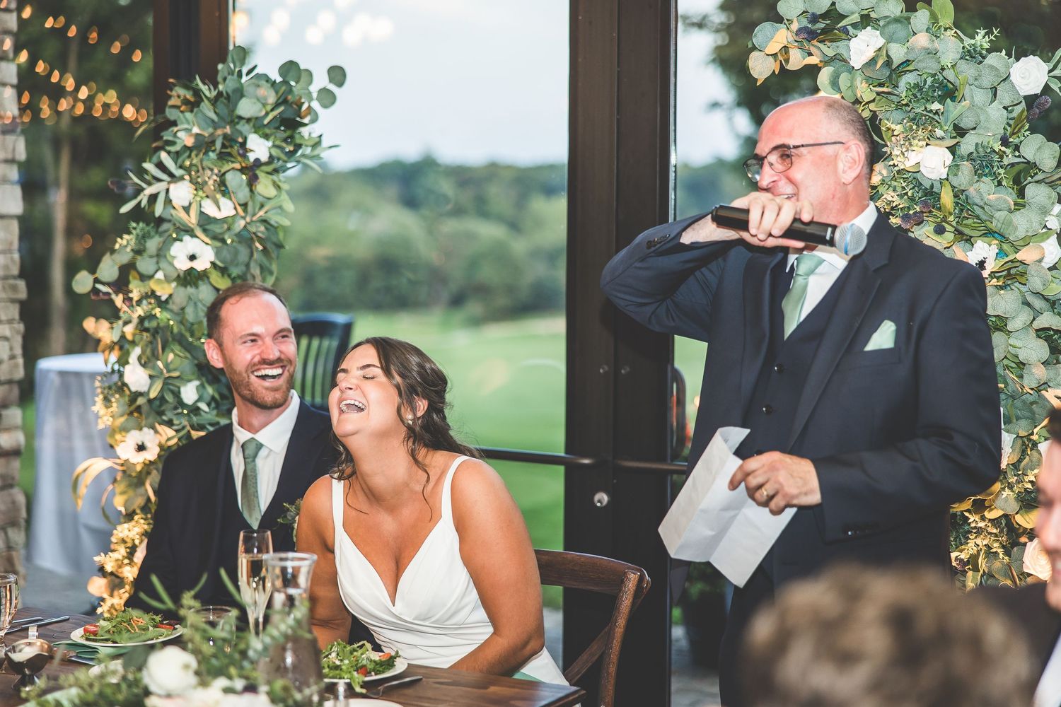 Wedding reception moments captured in a bright venue with floral decorations.