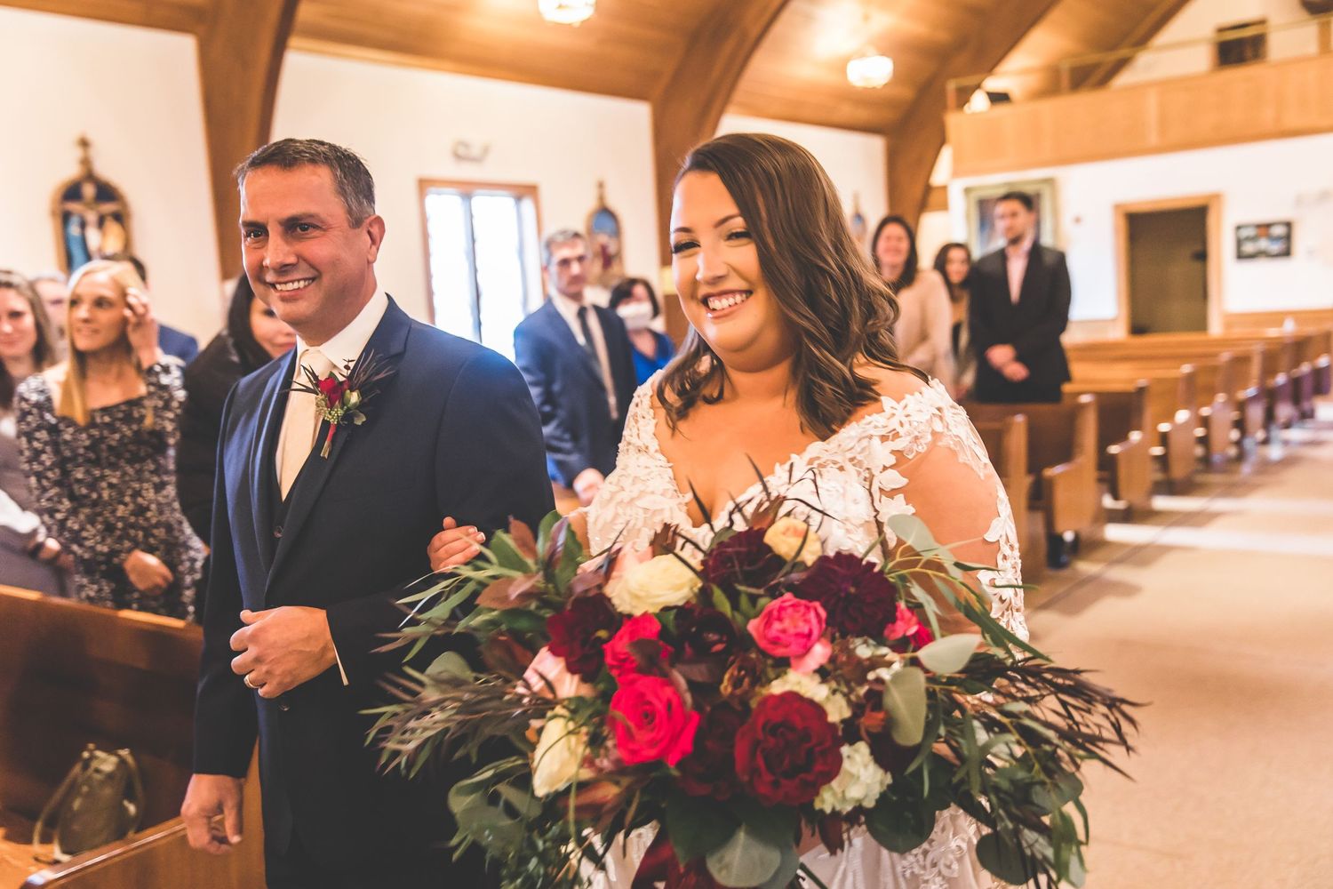 Wedding ceremony in progress inside traditional church sanctuary.