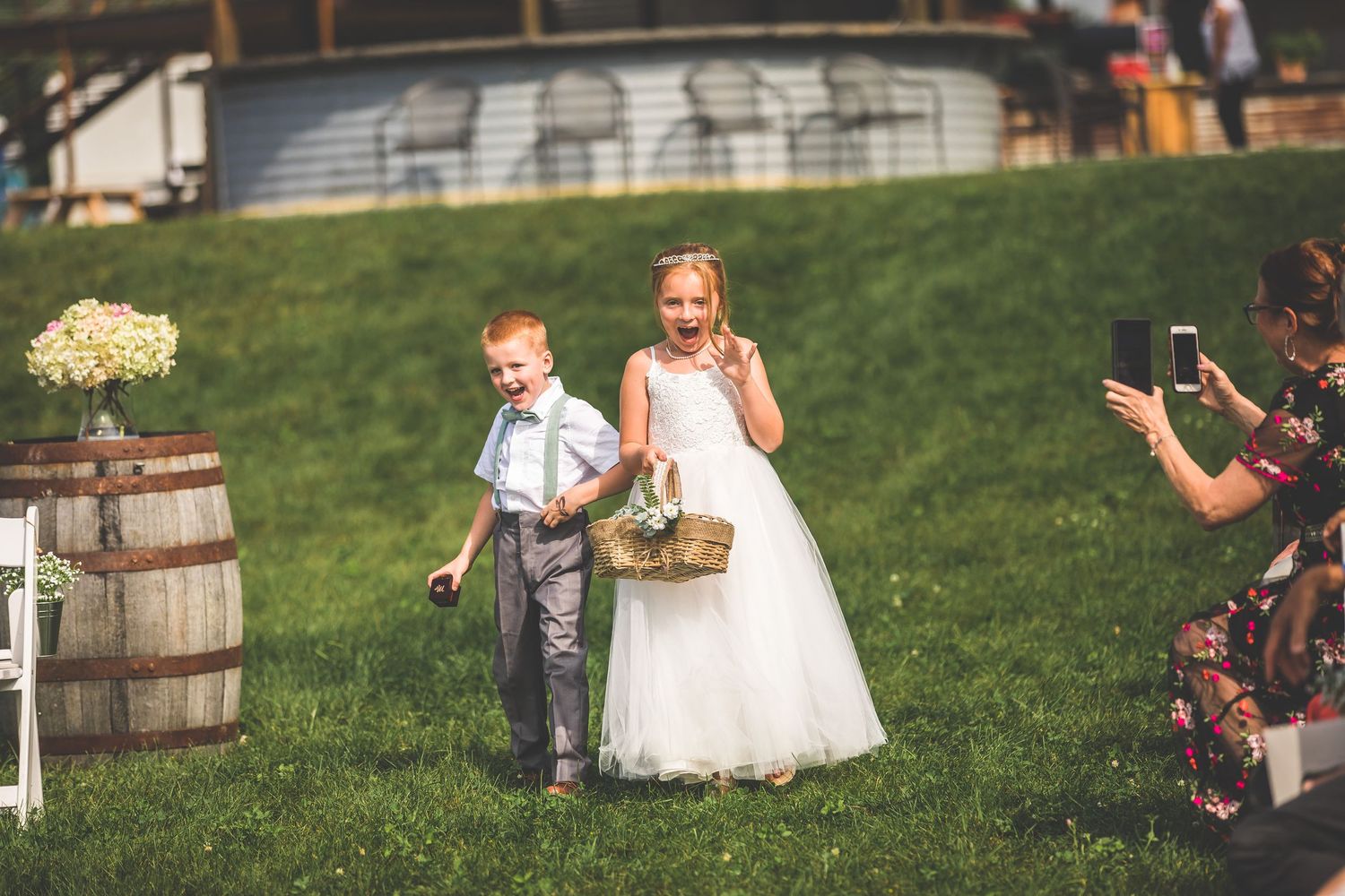 Children in formal attire participating in outdoor wedding ceremony.