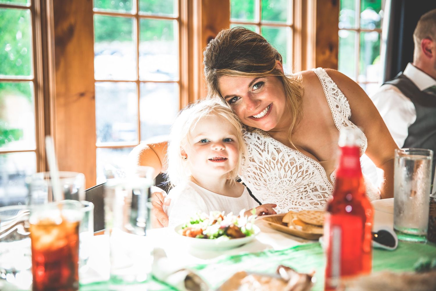 Sunlit wedding venue with large windows and natural decor creating a warm atmosphere.