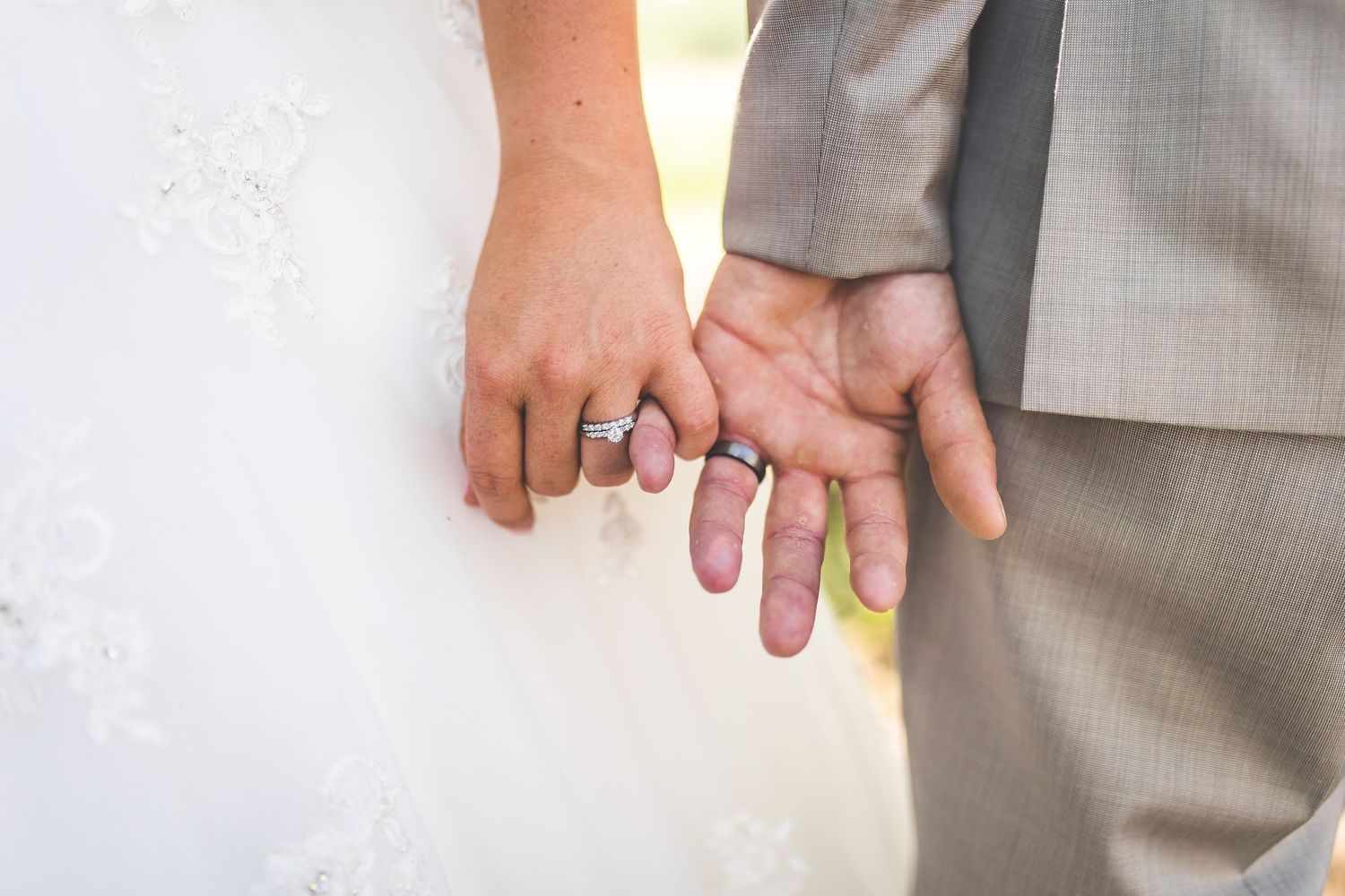 Close-up detail shots of wedding rings and hands against a light background.