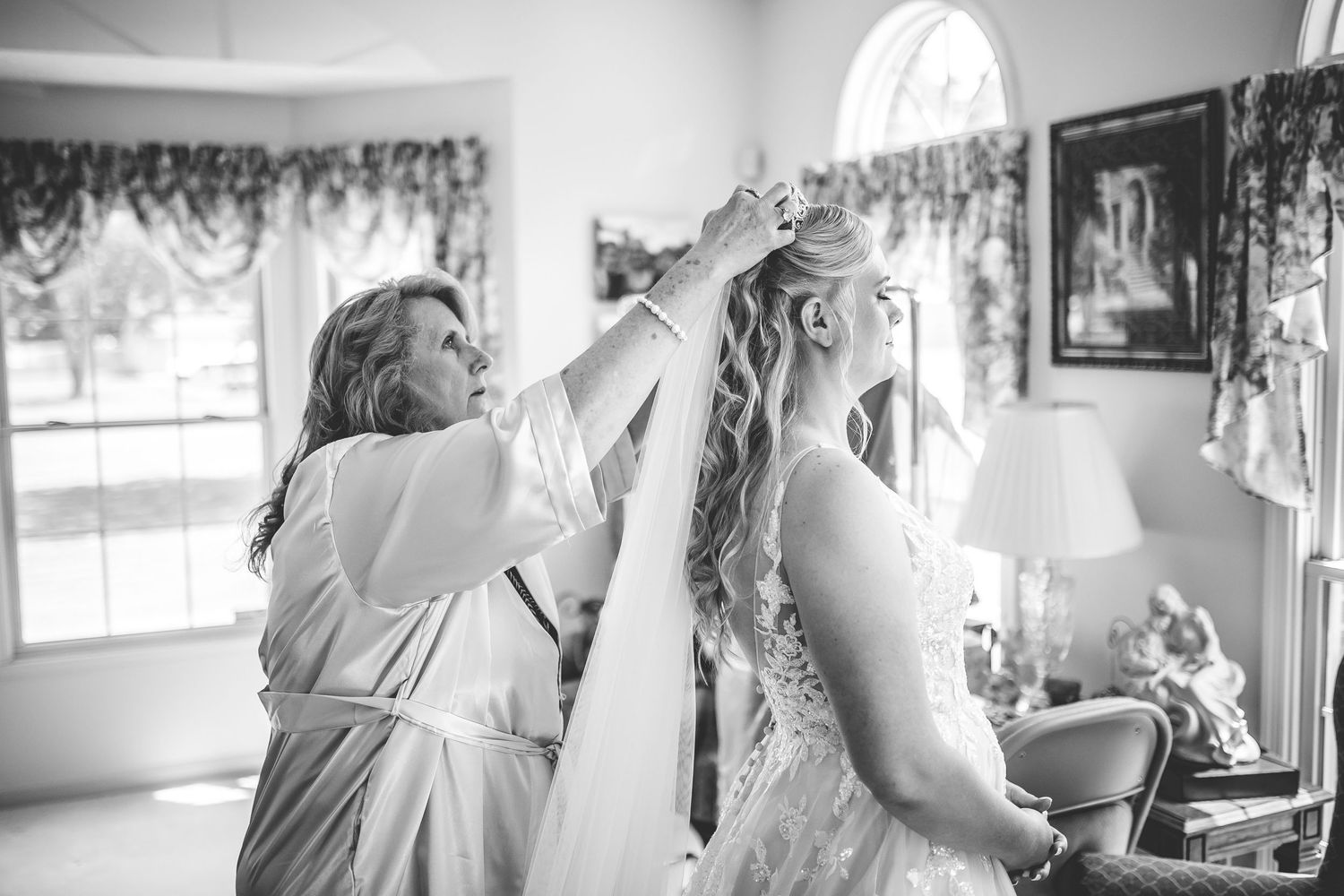 Black and white photo of wedding preparation moments.