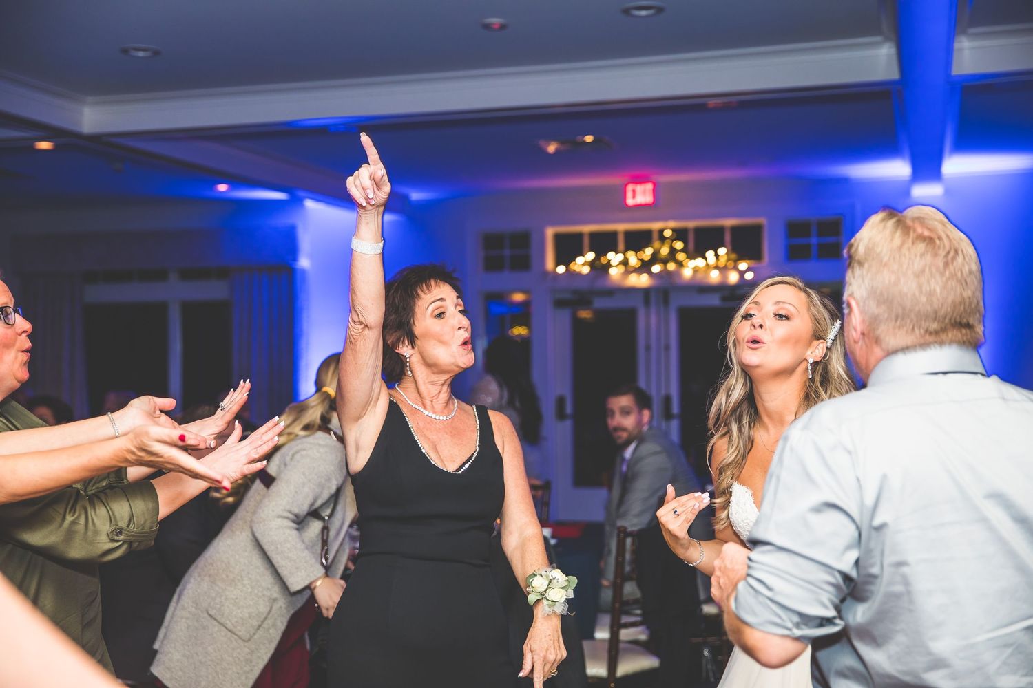 Wedding reception dance floor with blue uplighting and party atmosphere.