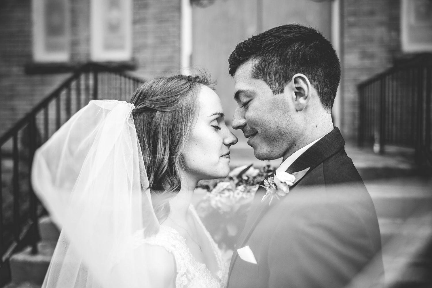 Black and white romantic wedding couple portraits showing tender moments and kisses.