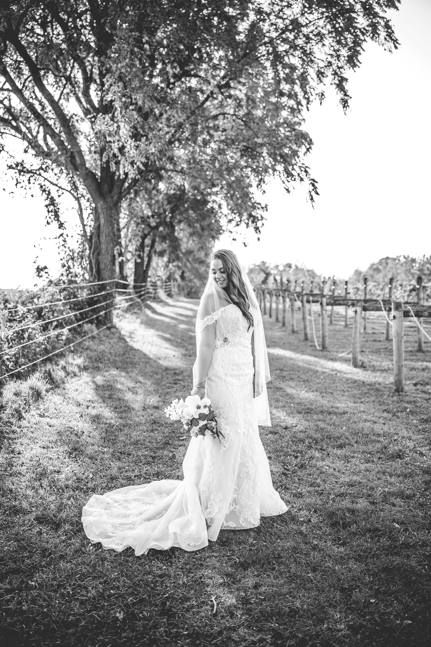 Black and white series of artistic bridal portraits on a scenic hillside path.