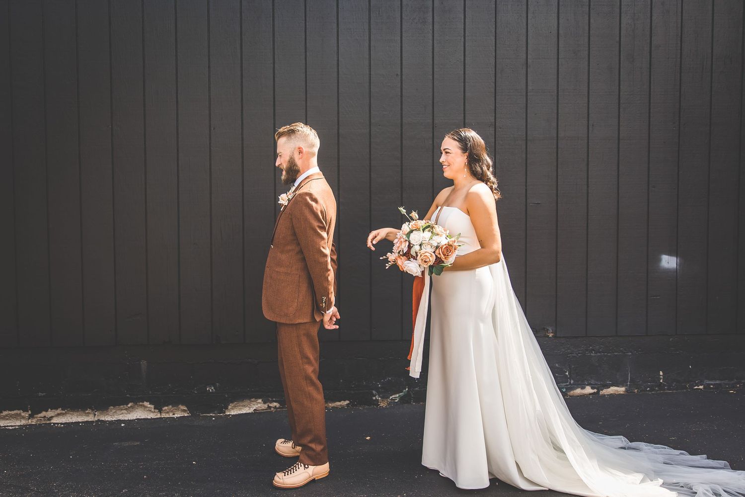 Wedding photos captured against a dark wooden wall showing romantic moments and dress details.