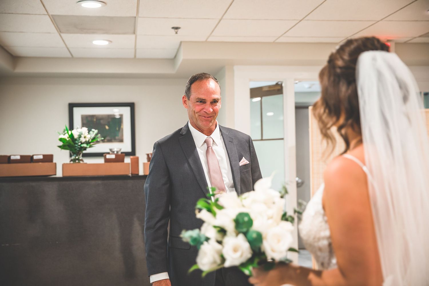 Indoor wedding preparation scene with elegant decor and lighting.