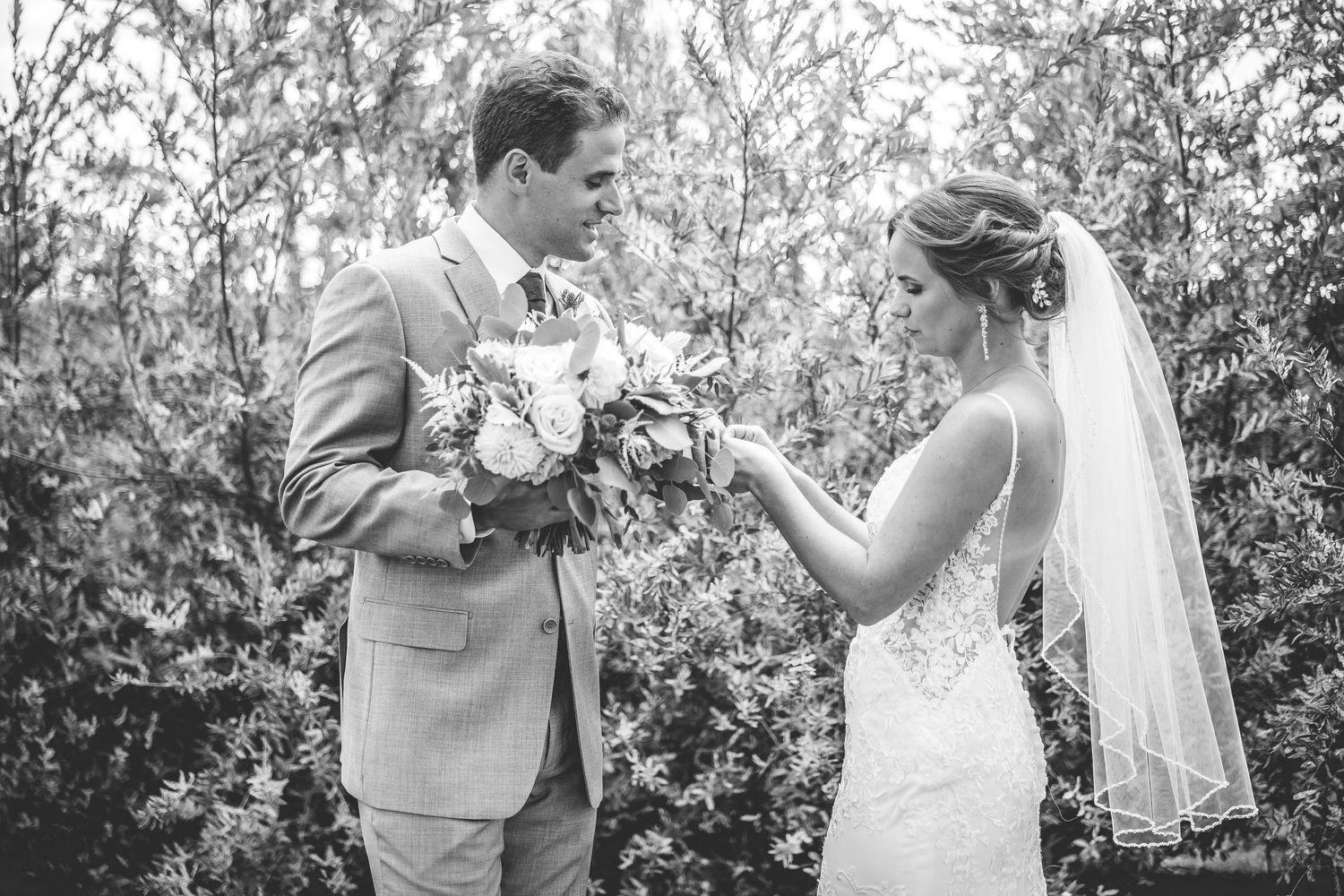 Couple laughing together during outdoor wedding photoshoot.