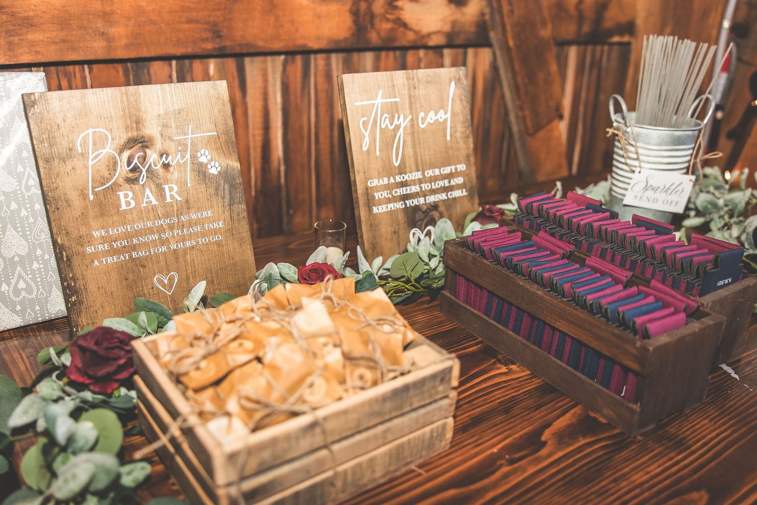 Rustic wooden table settings with decorative elements and place cards for a wedding reception.