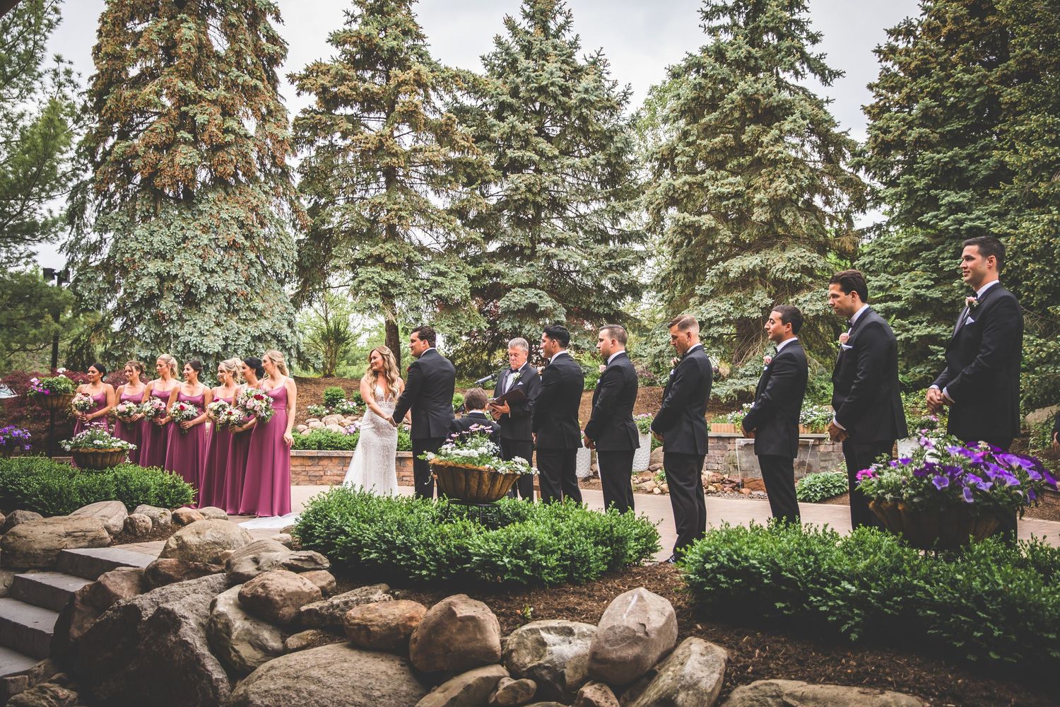 Outdoor wedding ceremony setup with evergreen trees in the background.