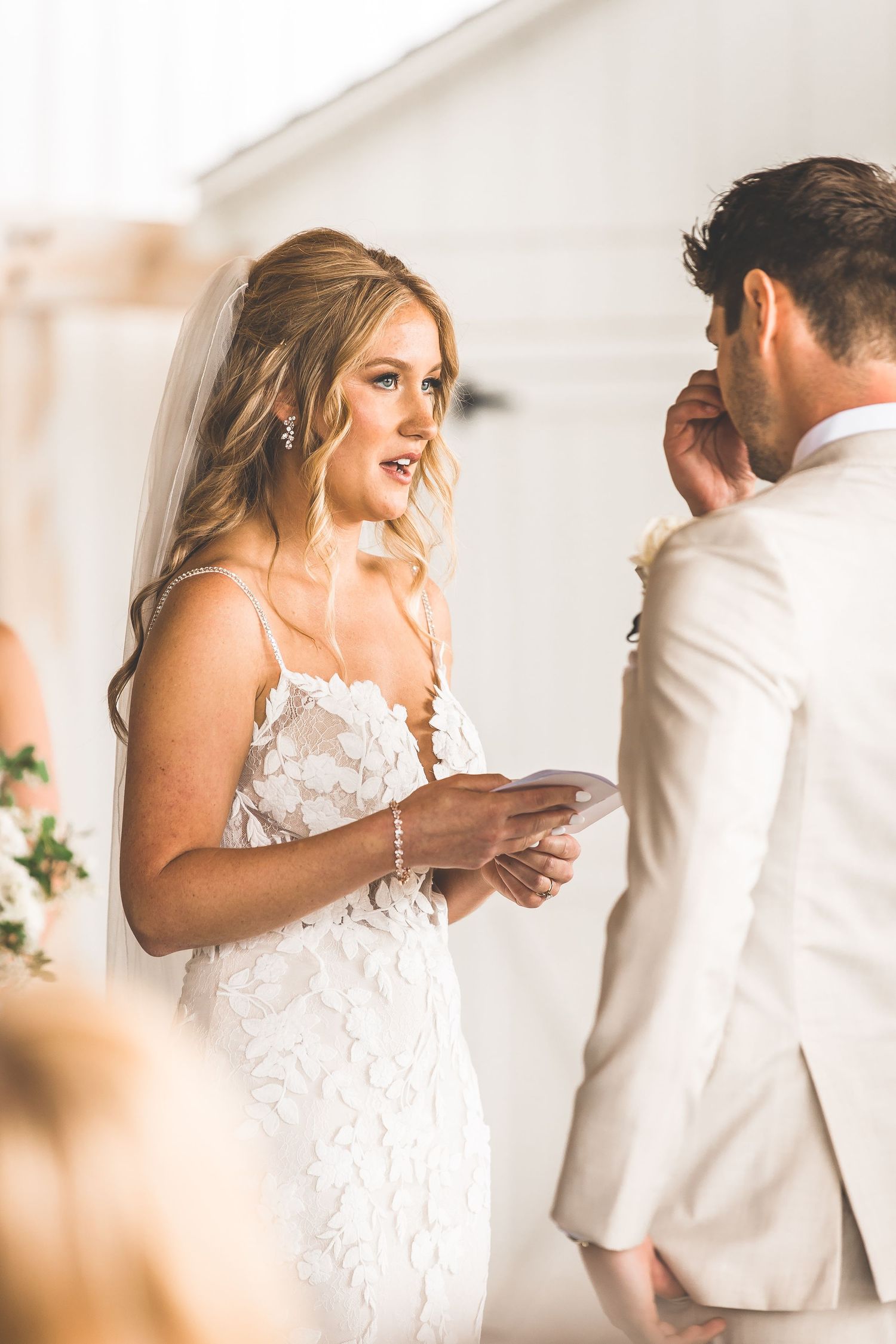 A bride and groom share an intimate first look moment in a bright indoor setting.