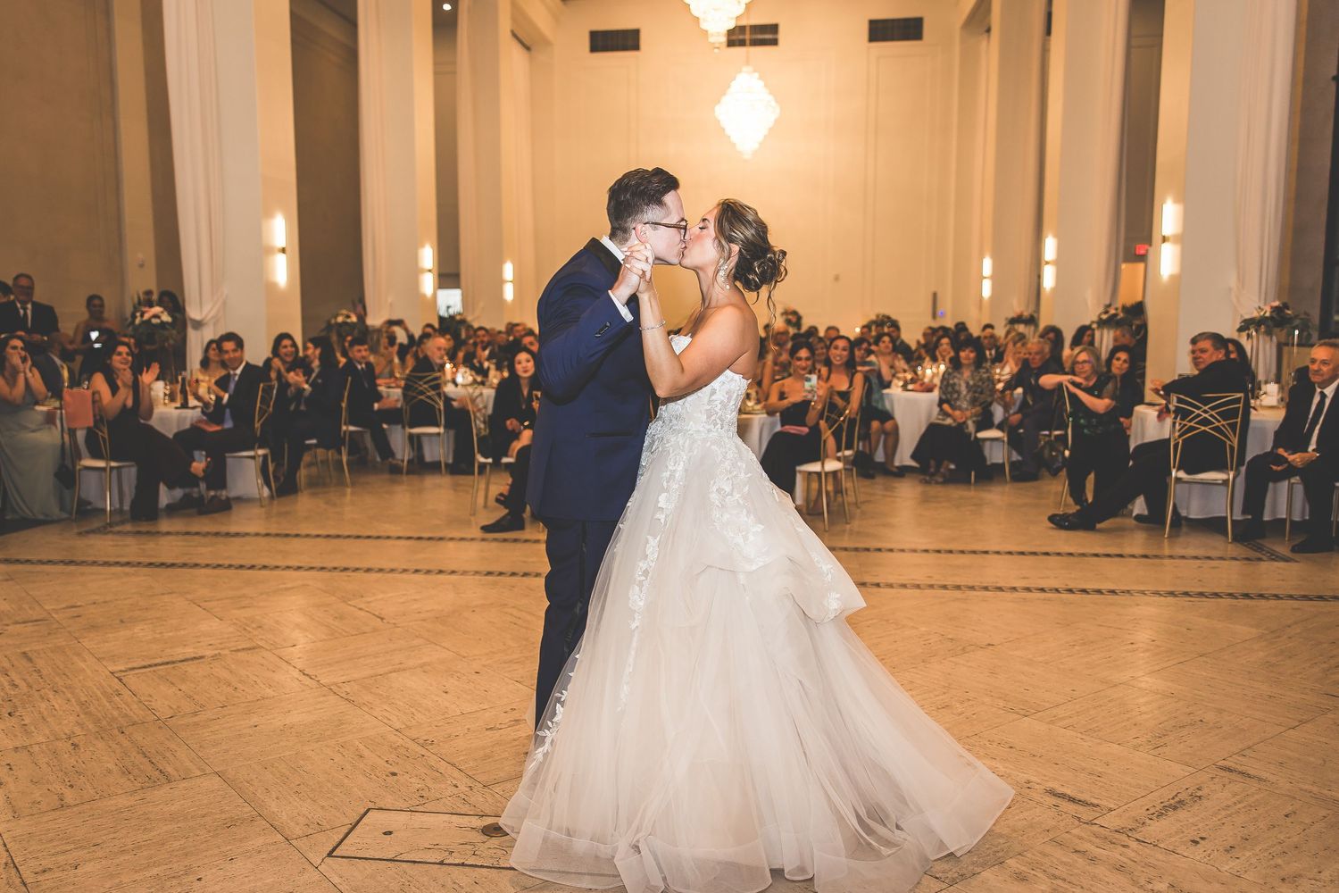 Wedding couple performs choreographed dance routine in stunning ballroom venue.