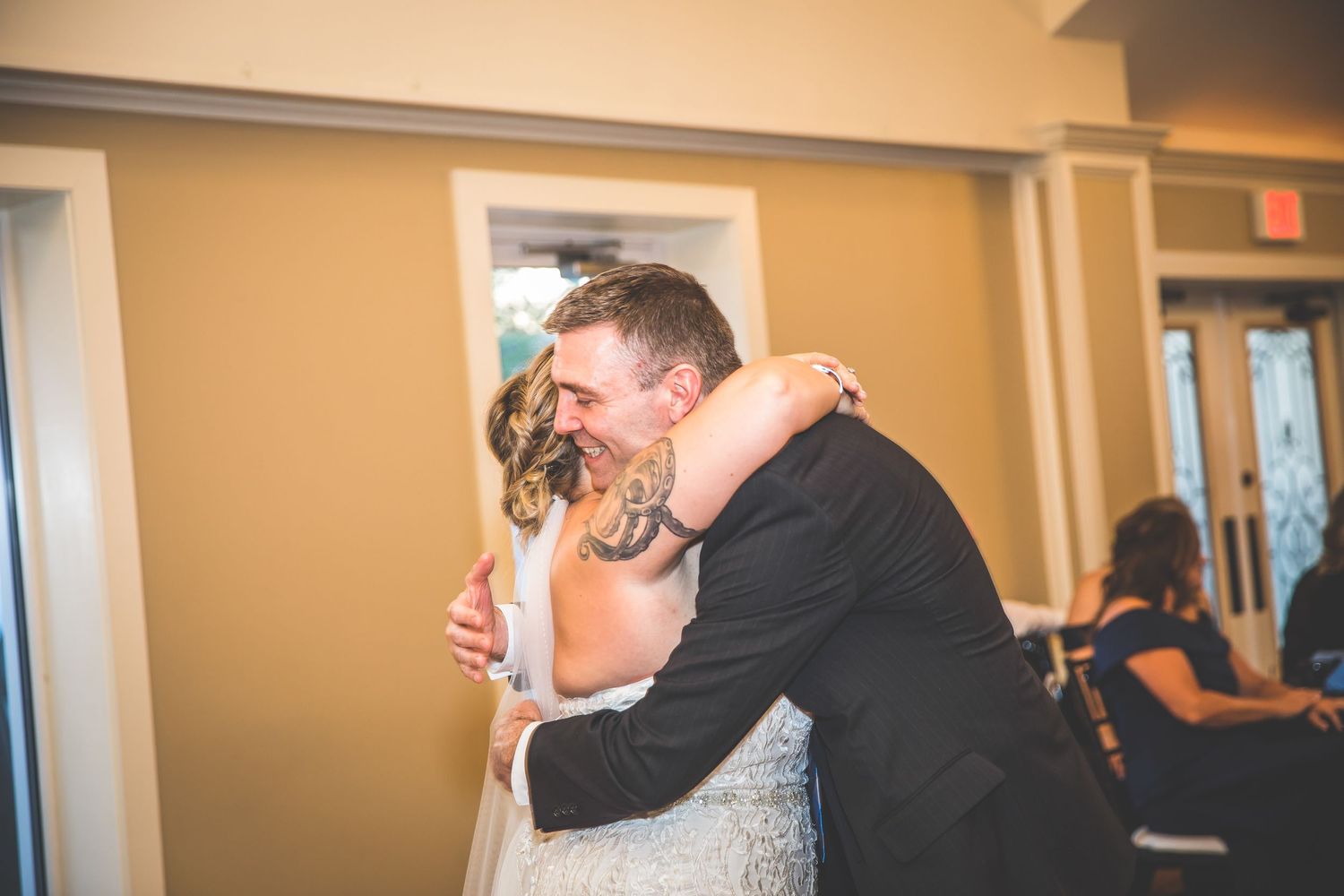 Indoor wedding reception venue with warm lighting and cream colored walls.