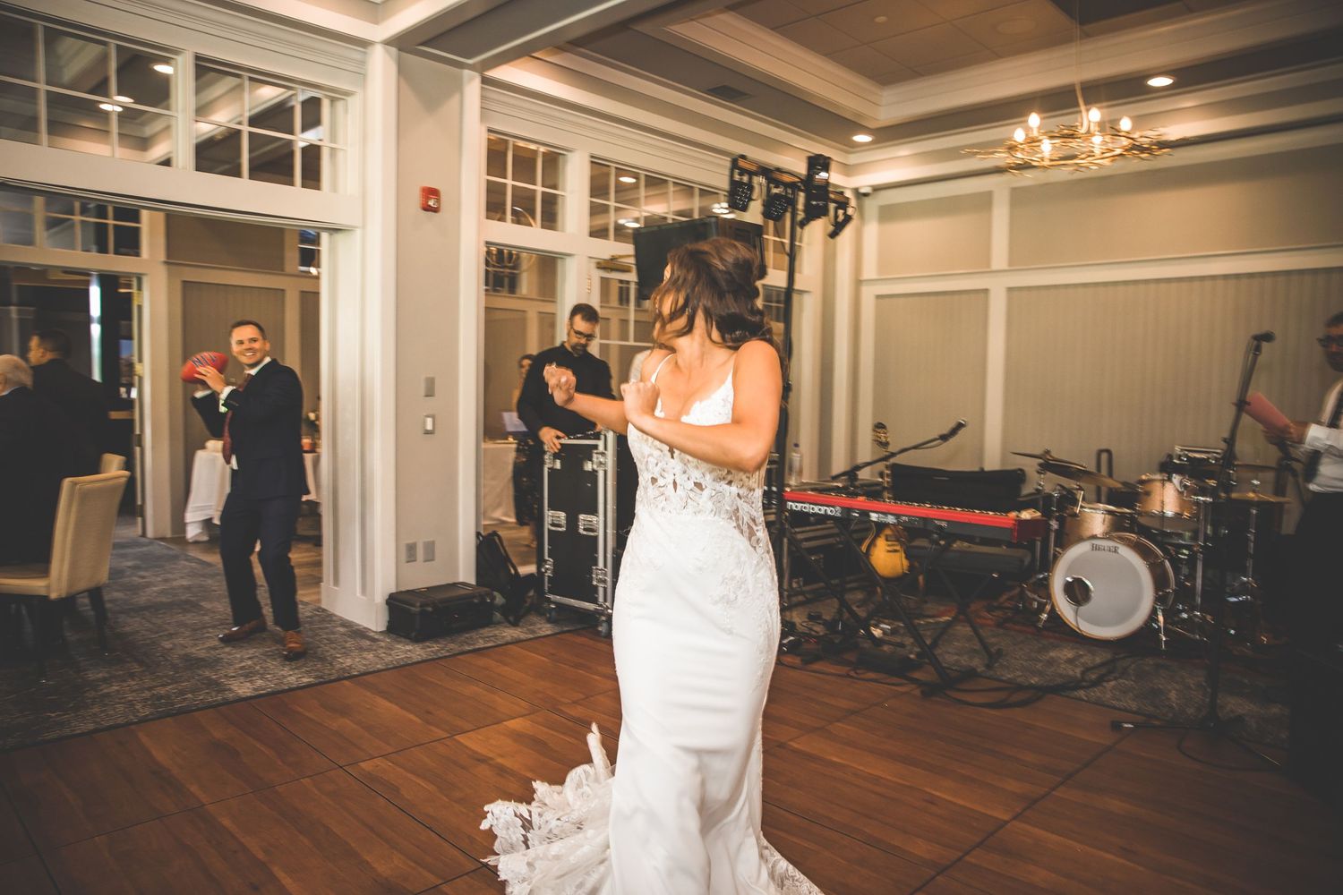 Wedding reception venue with hardwood floors and elegant white interior details.