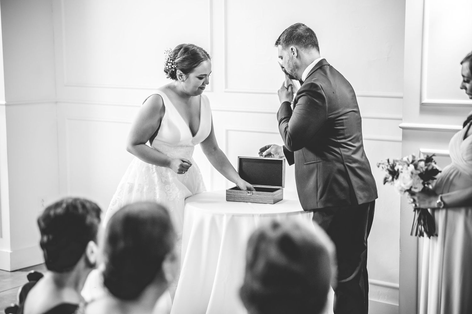 Black and white photo capturing emotional wedding ceremony moments.