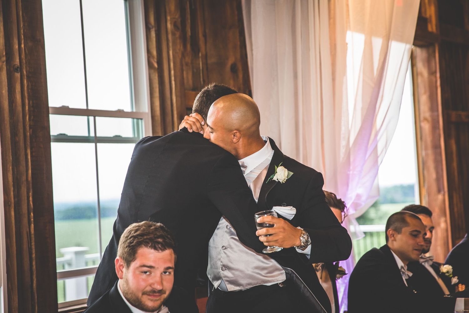 Emotional moment shared between guests during wedding reception speeches.