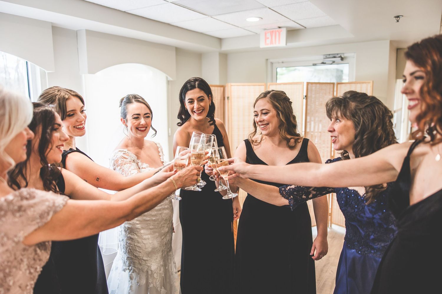 Wedding party toasts with champagne during pre-ceremony preparations.