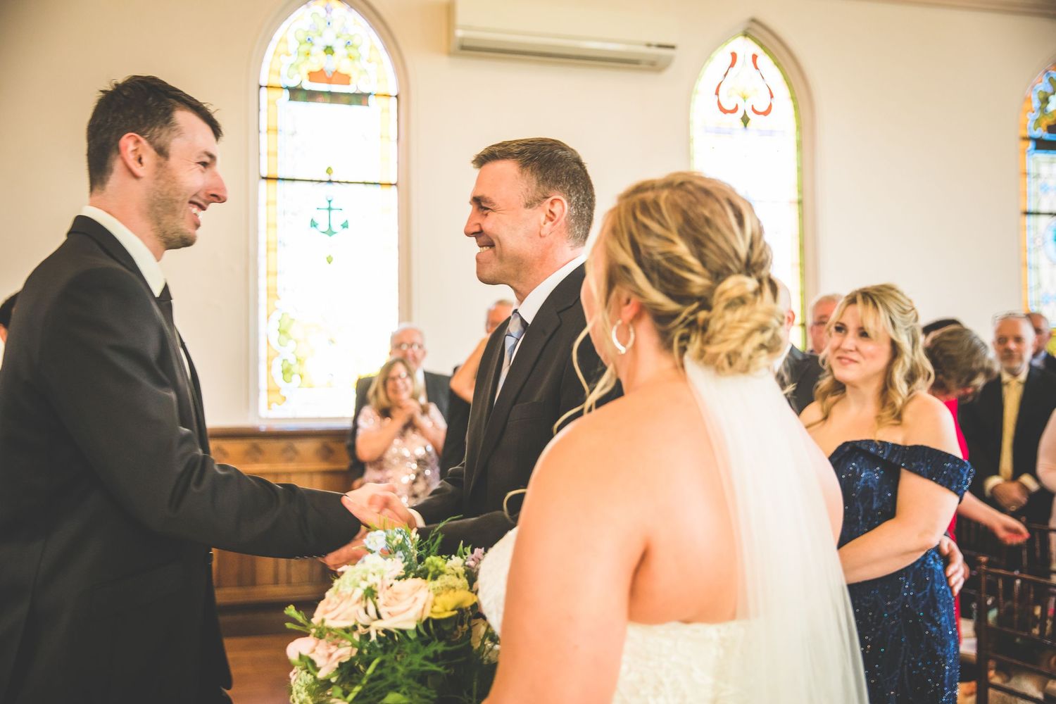 Wedding celebration captured in a church with elegant architectural details.