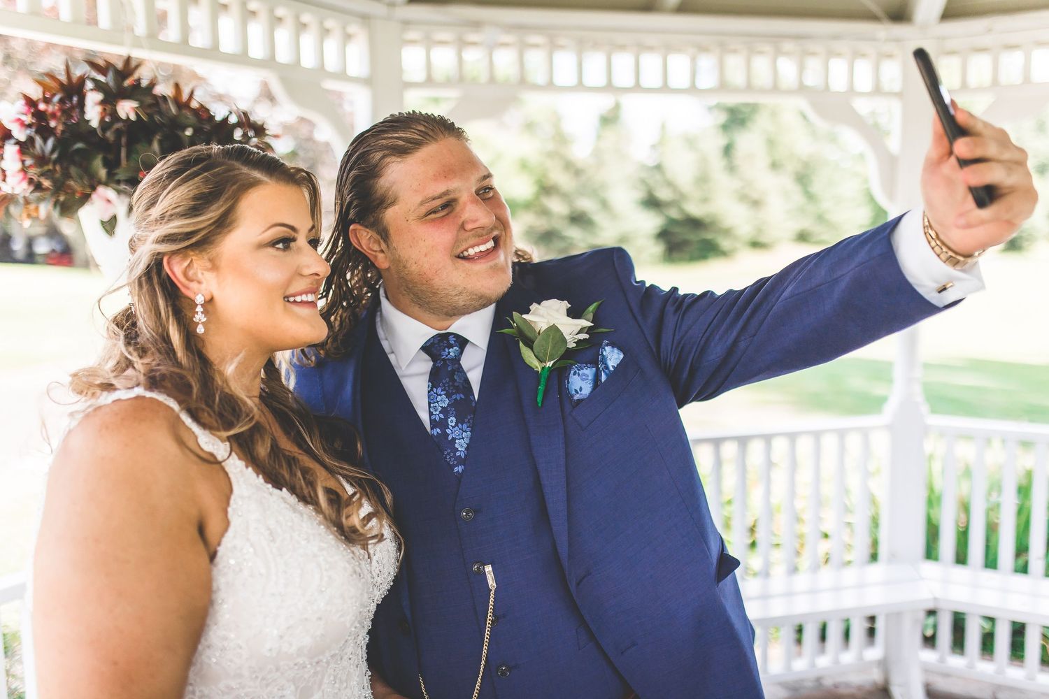 Newlyweds sharing intimate dance moments under decorated gazebo.
