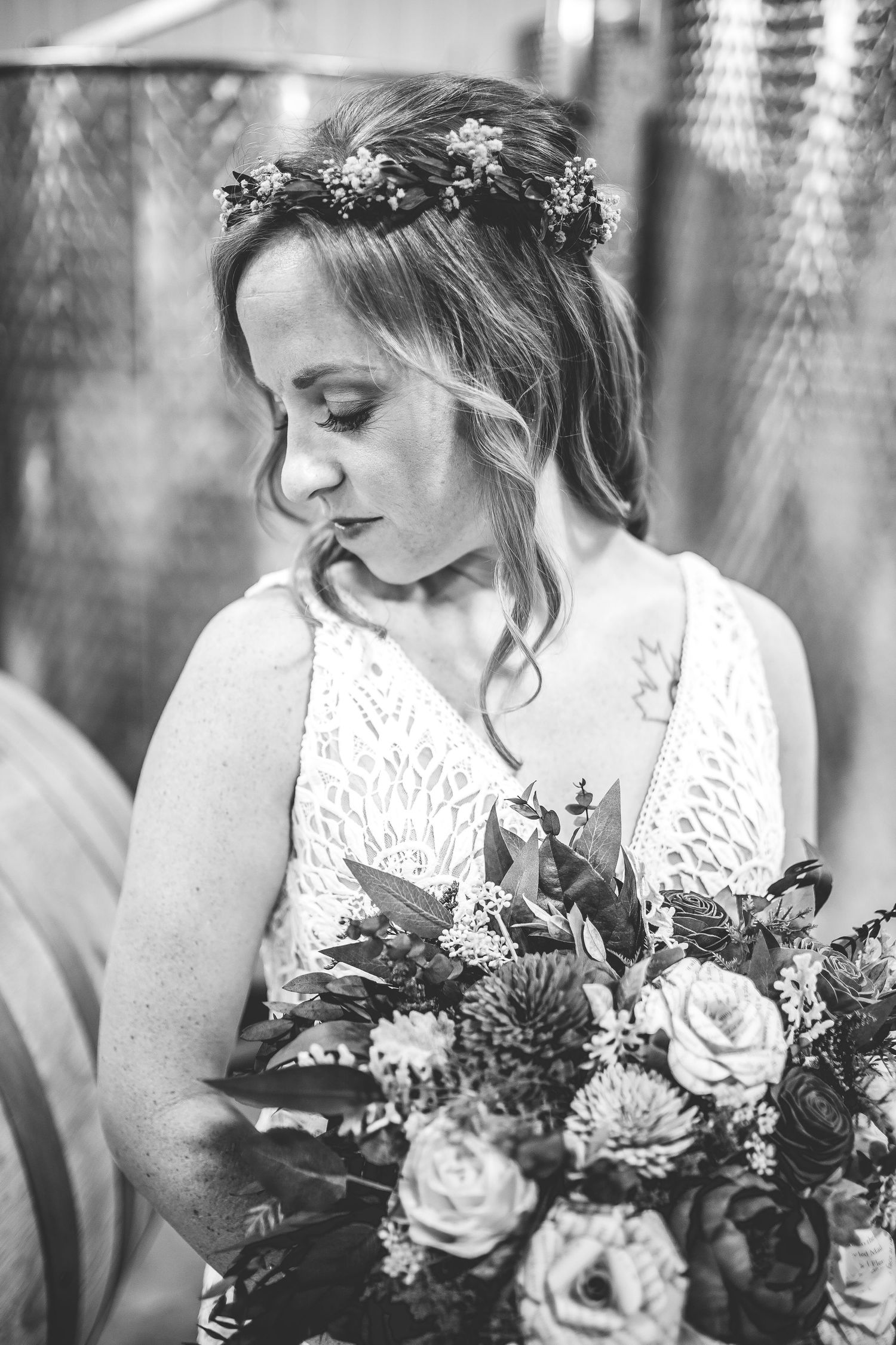 Close-up details of a bridal bouquet with white roses and purple accents.