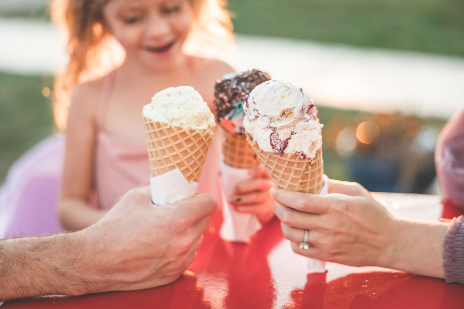 People enjoying ice cream cones together on a warm summer day.