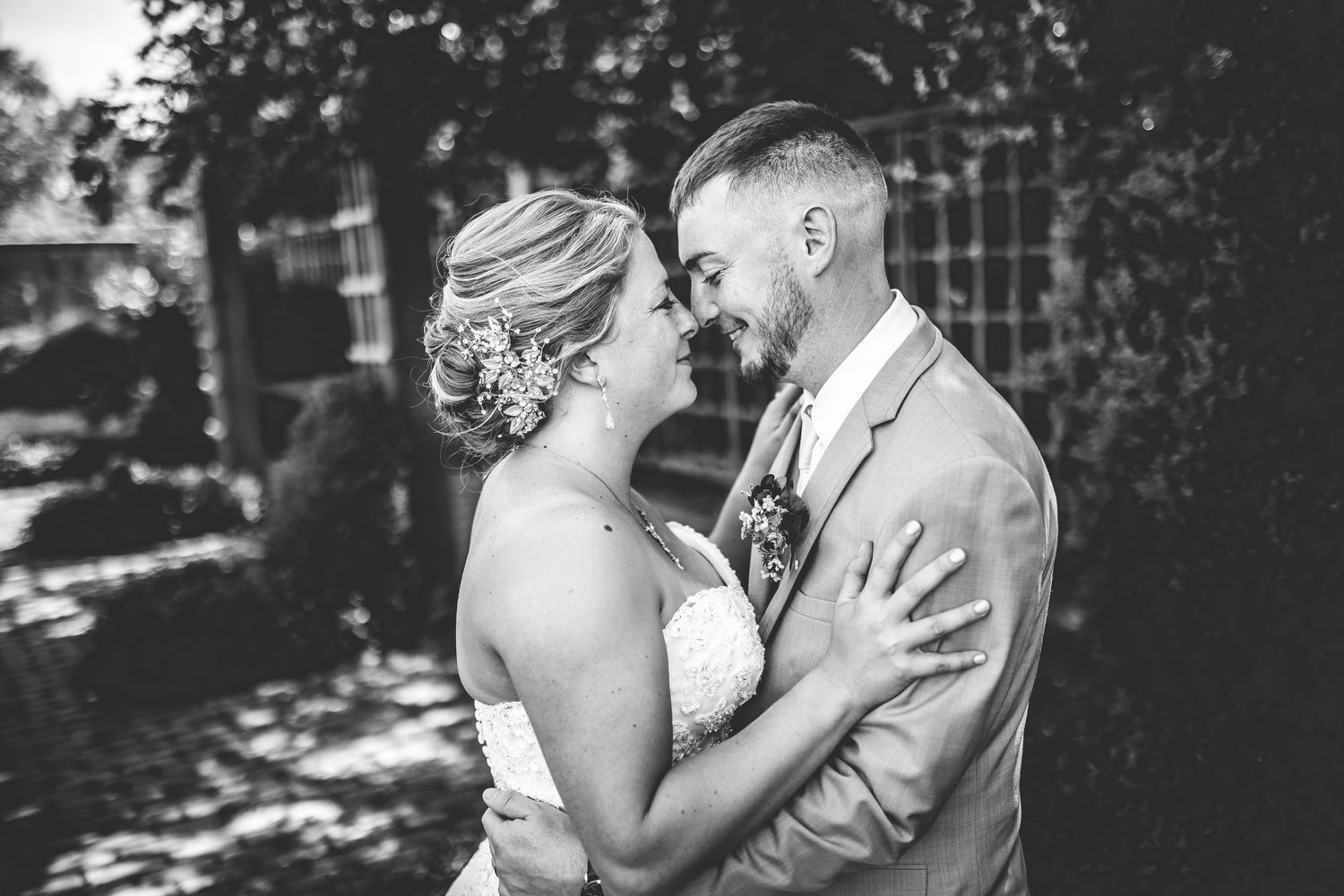 Black and white romantic wedding portraits showing tender moments between newlyweds.