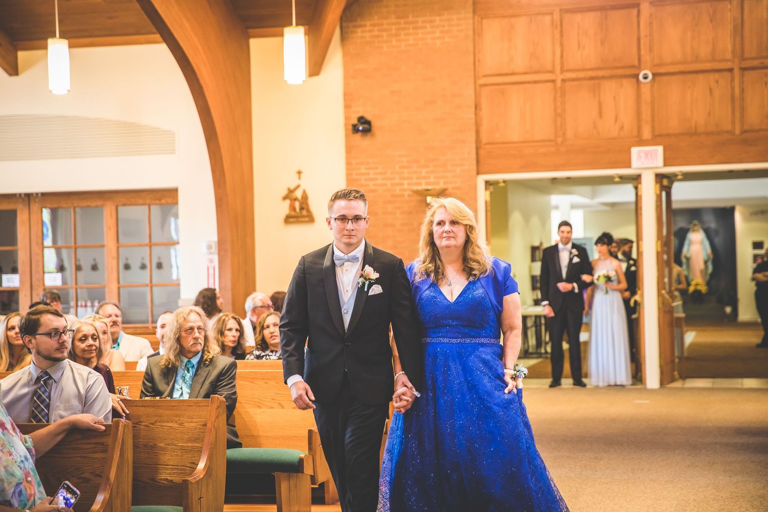Wedding ceremony in a church with wooden beams and warm lighting.