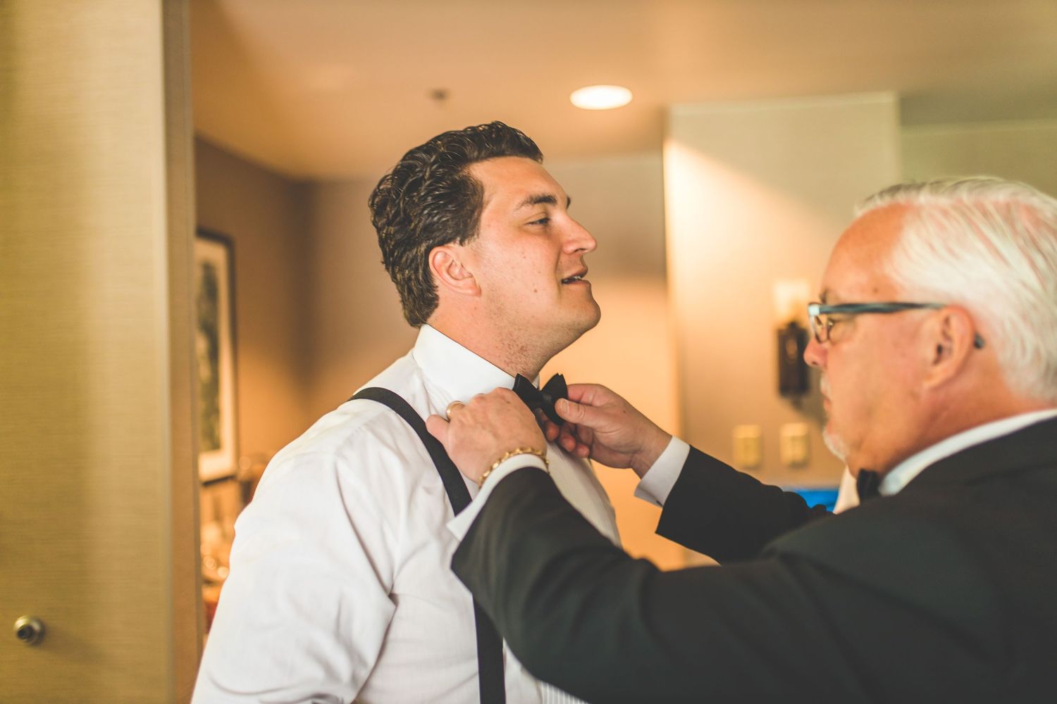 Wedding party members in formal attire share candid moments during preparations.