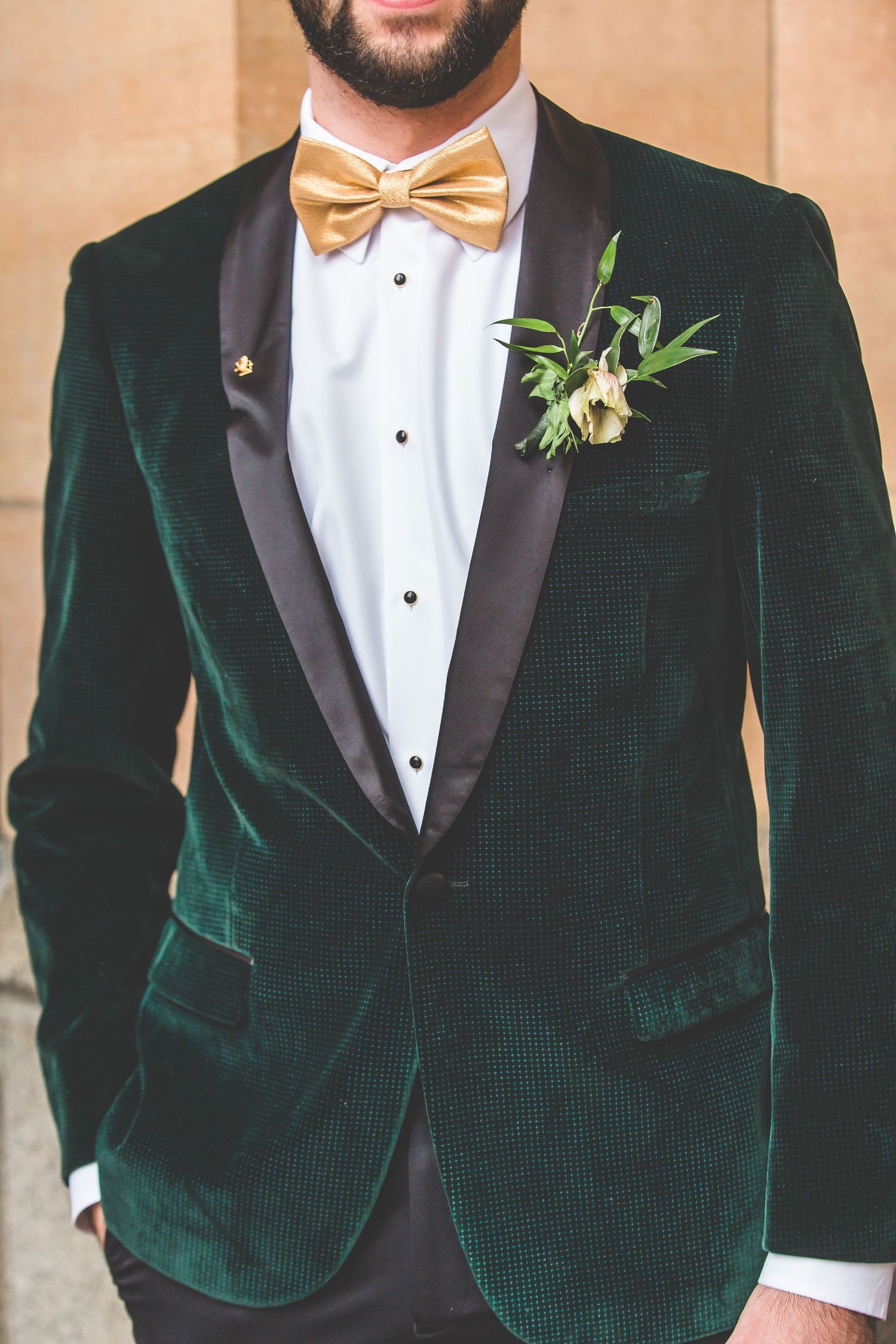 Close-up details of emerald green velvet tuxedo jackets with black lapels.