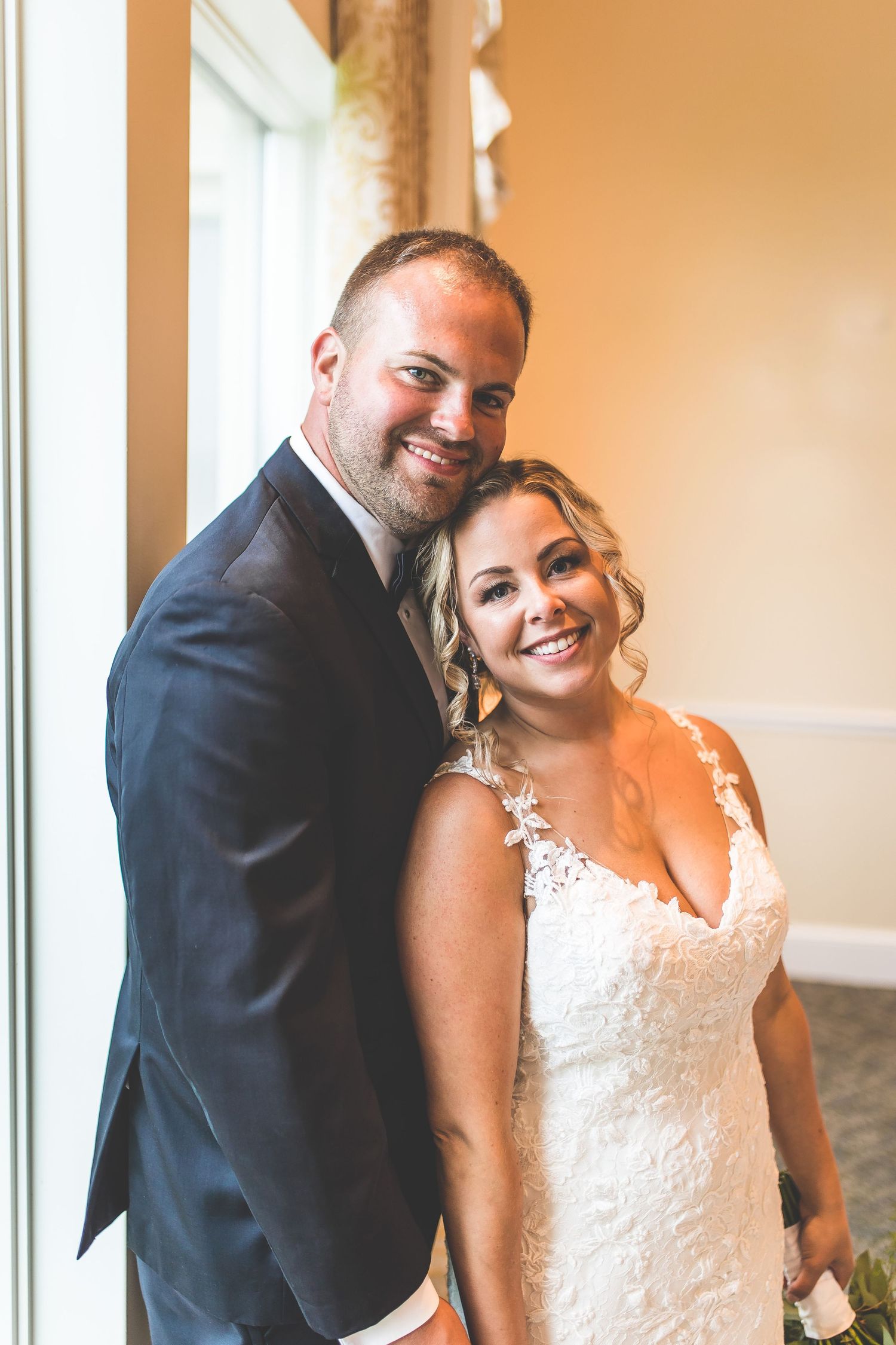 Indoor wedding portraits showing joyful moments between newlyweds.