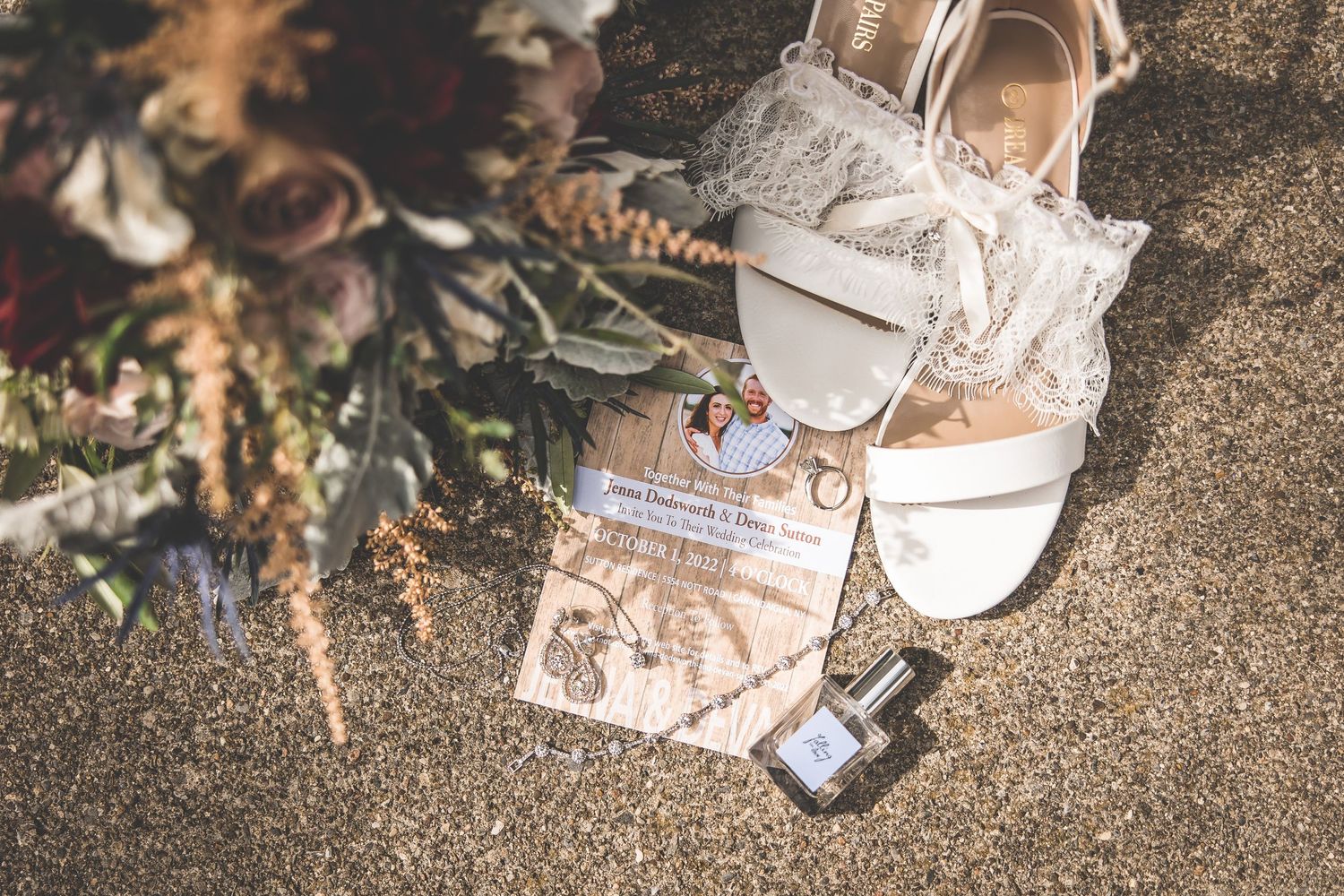 Wedding rings and decorative details arranged on a rustic stone surface.