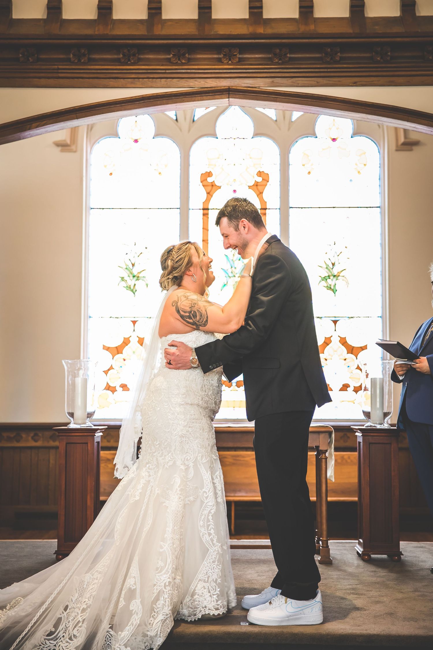 Wedding ceremony progression showing emotional moments between couple in front of church windows.