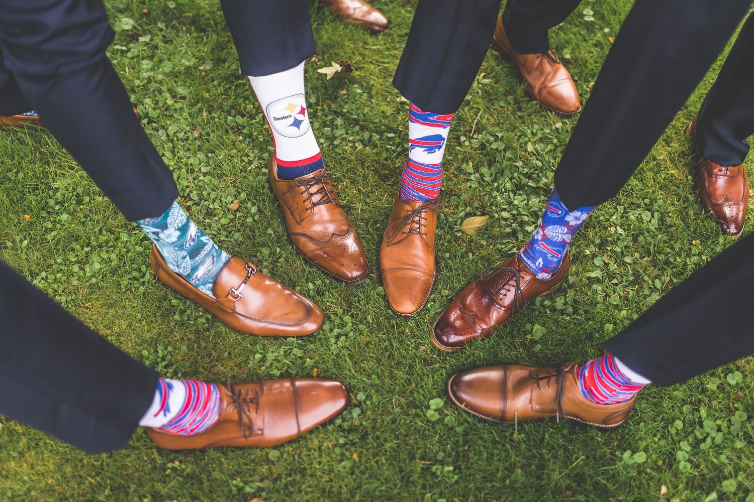 Fun sock photo showing colorful socks and brown dress shoes worn by groomsmen.