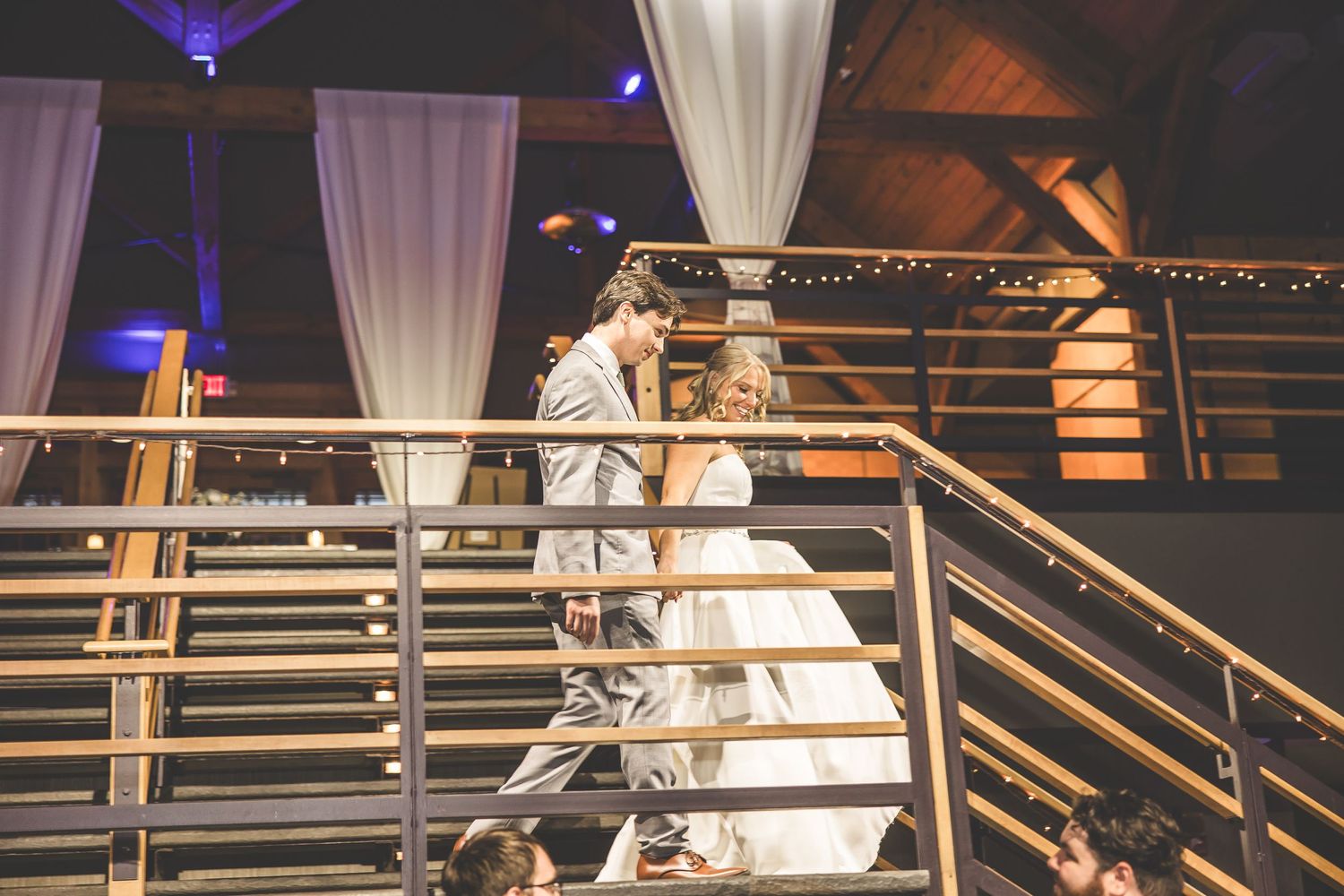 Wedding reception space with dramatic lighting and architectural details.