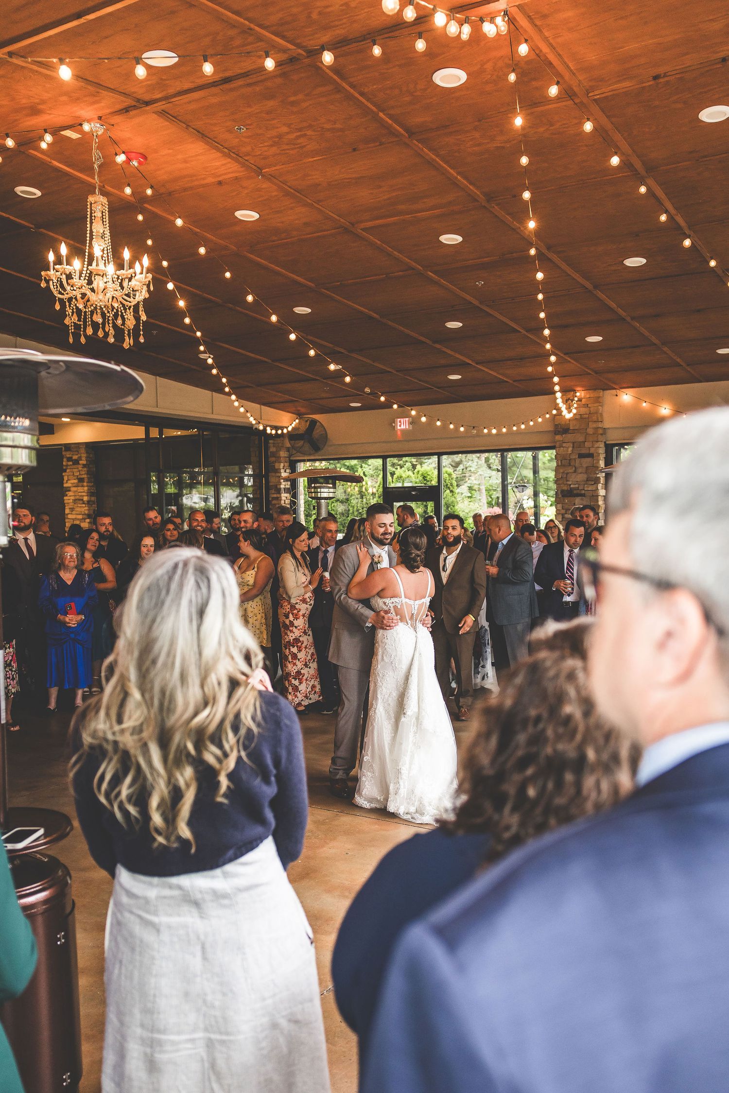 Wedding guests watch the dance floor during reception celebration.