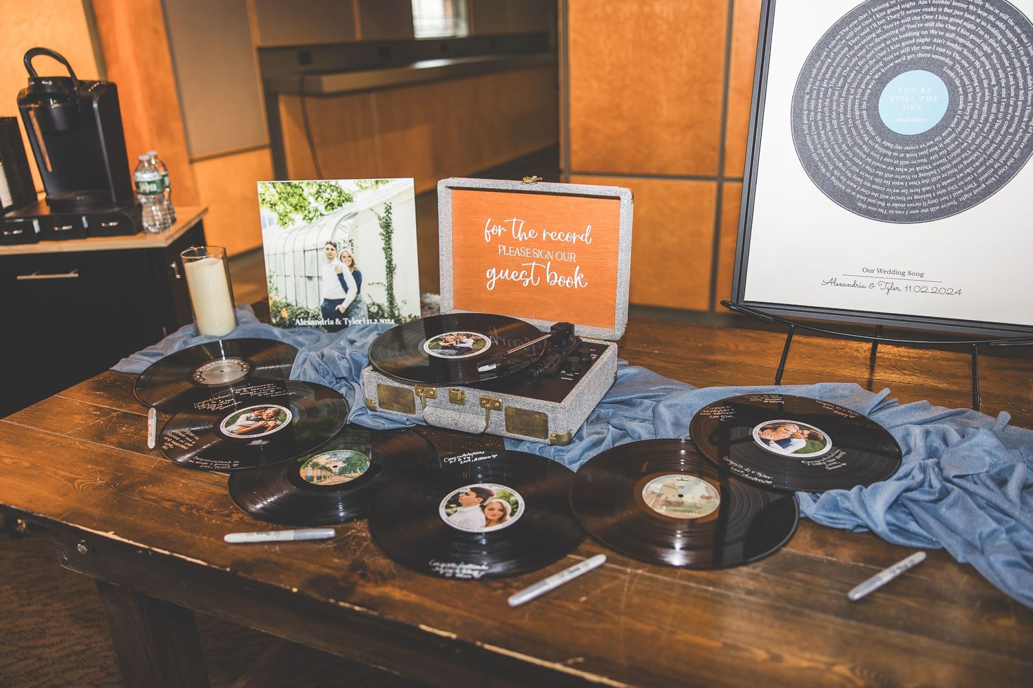 Vintage vinyl records arranged on a rustic wooden table create a nostalgic wedding display.