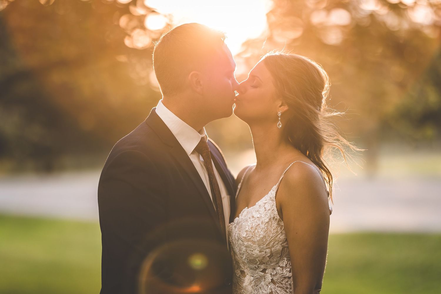 Romantic sunset portraits of newlyweds with golden bokeh lighting effects.