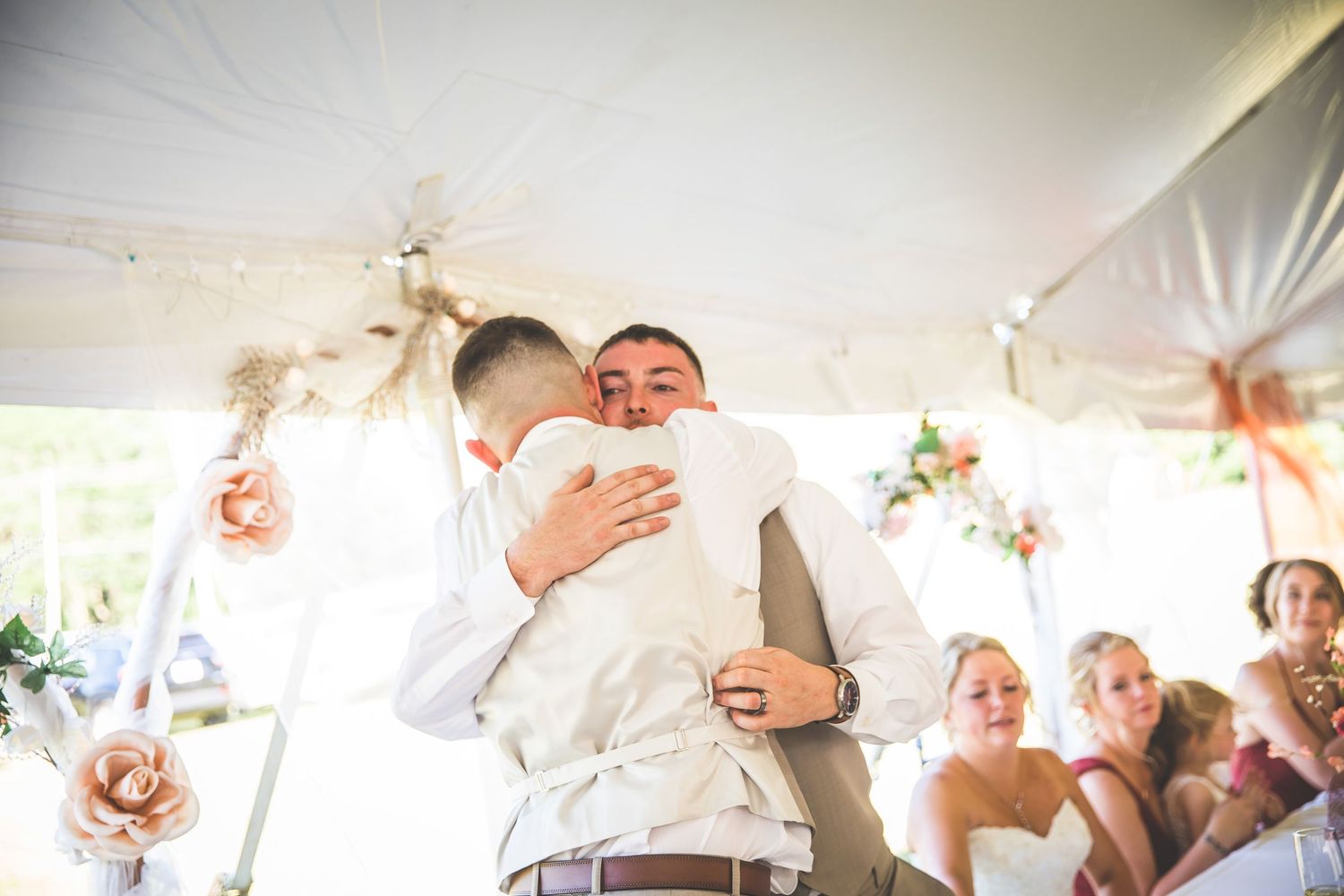 Candid moments captured during wedding reception toasts and celebrations.