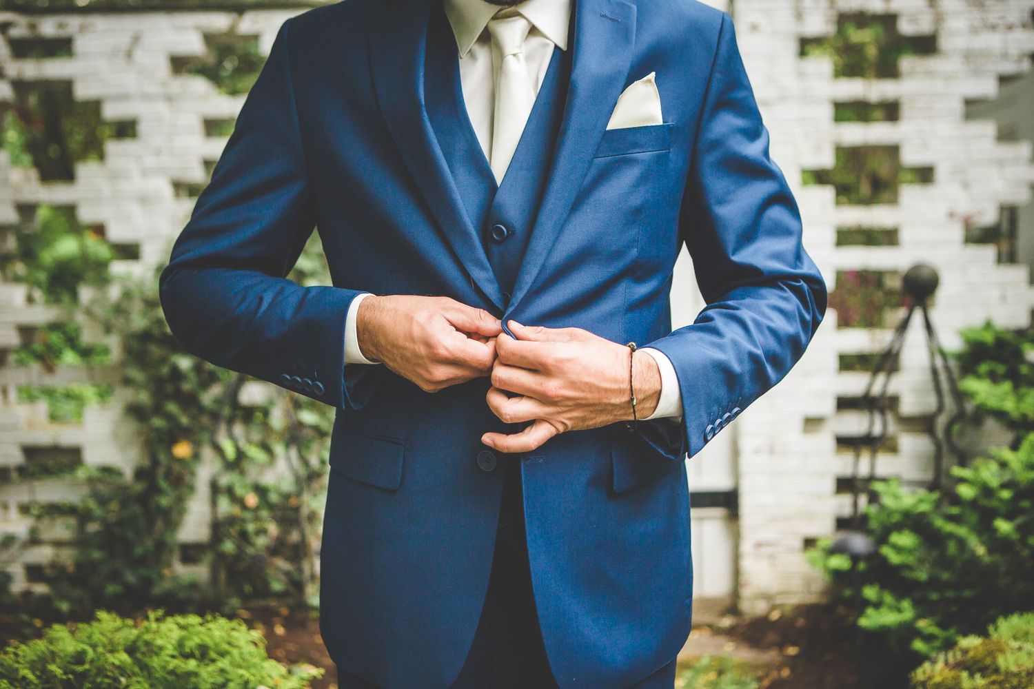 Details of groom's royal blue suit and accessories shown in close-up shots.
