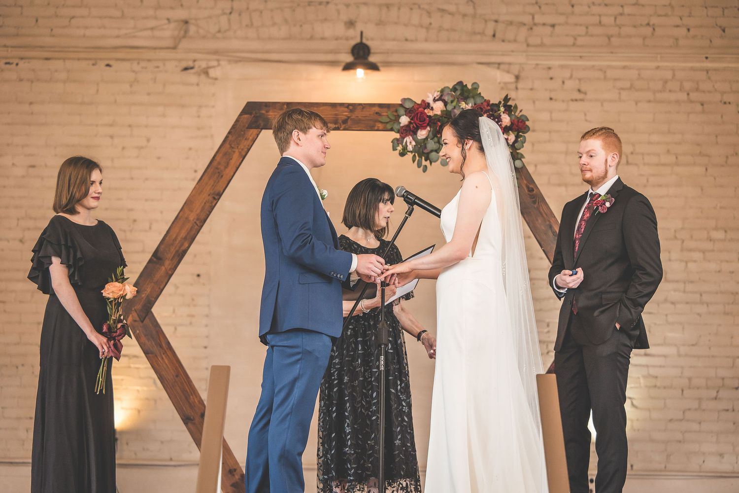 Sequential wedding ceremony photos showing special moments against rustic brick backdrop.