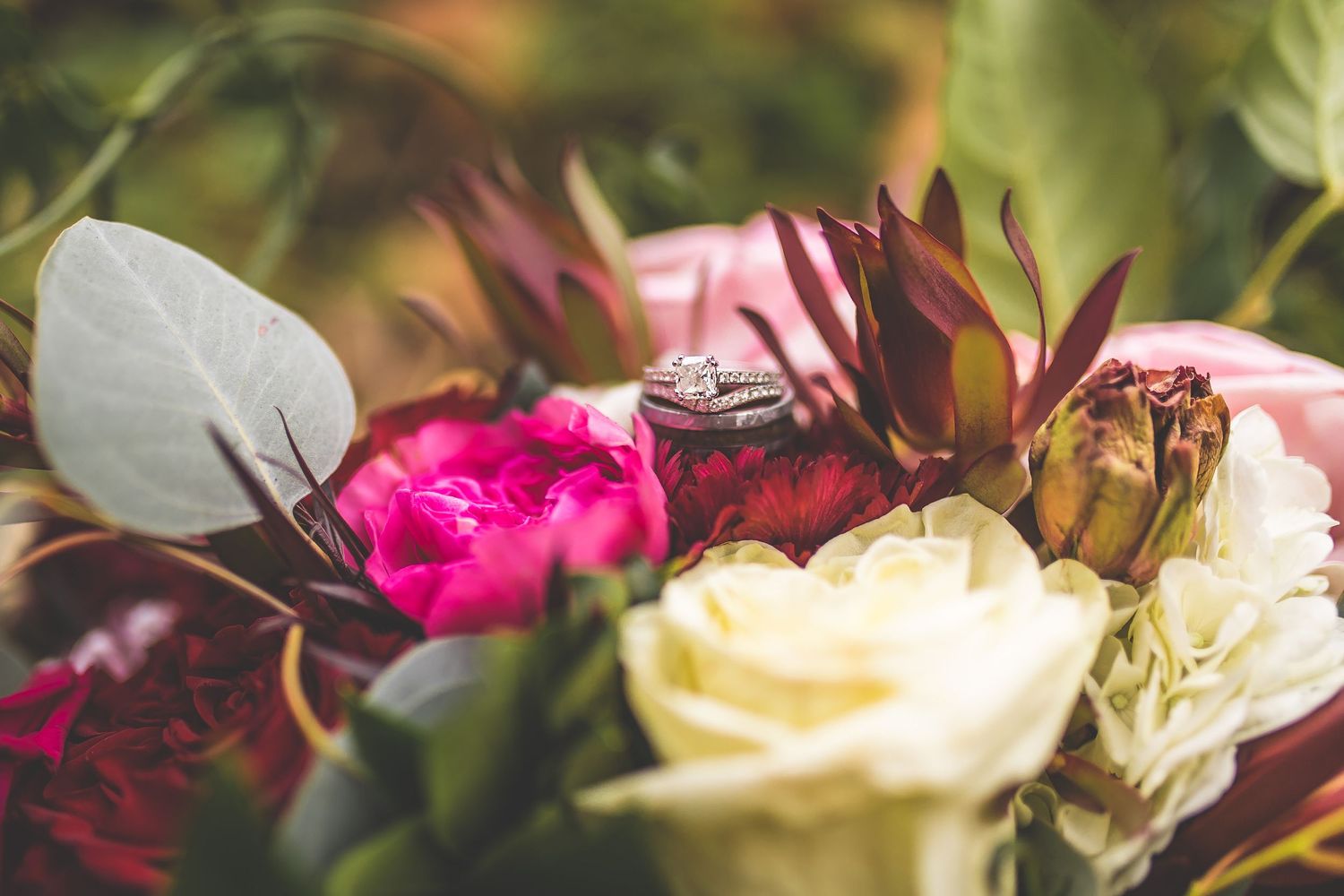 Close-up of pink and white wedding flowers with delicate petals and greenery.