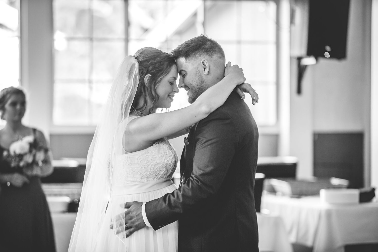 Black and white photo of a couple sharing an intimate dance moment at their wedding reception.