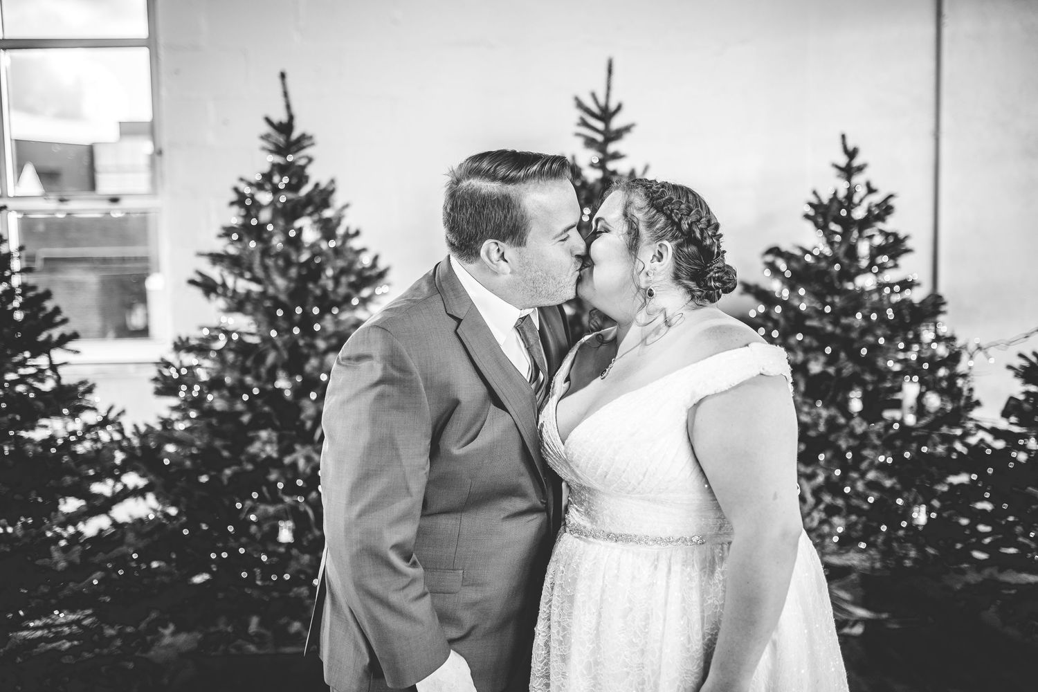A romantic winter wedding photo shoot with evergreen trees in the background.